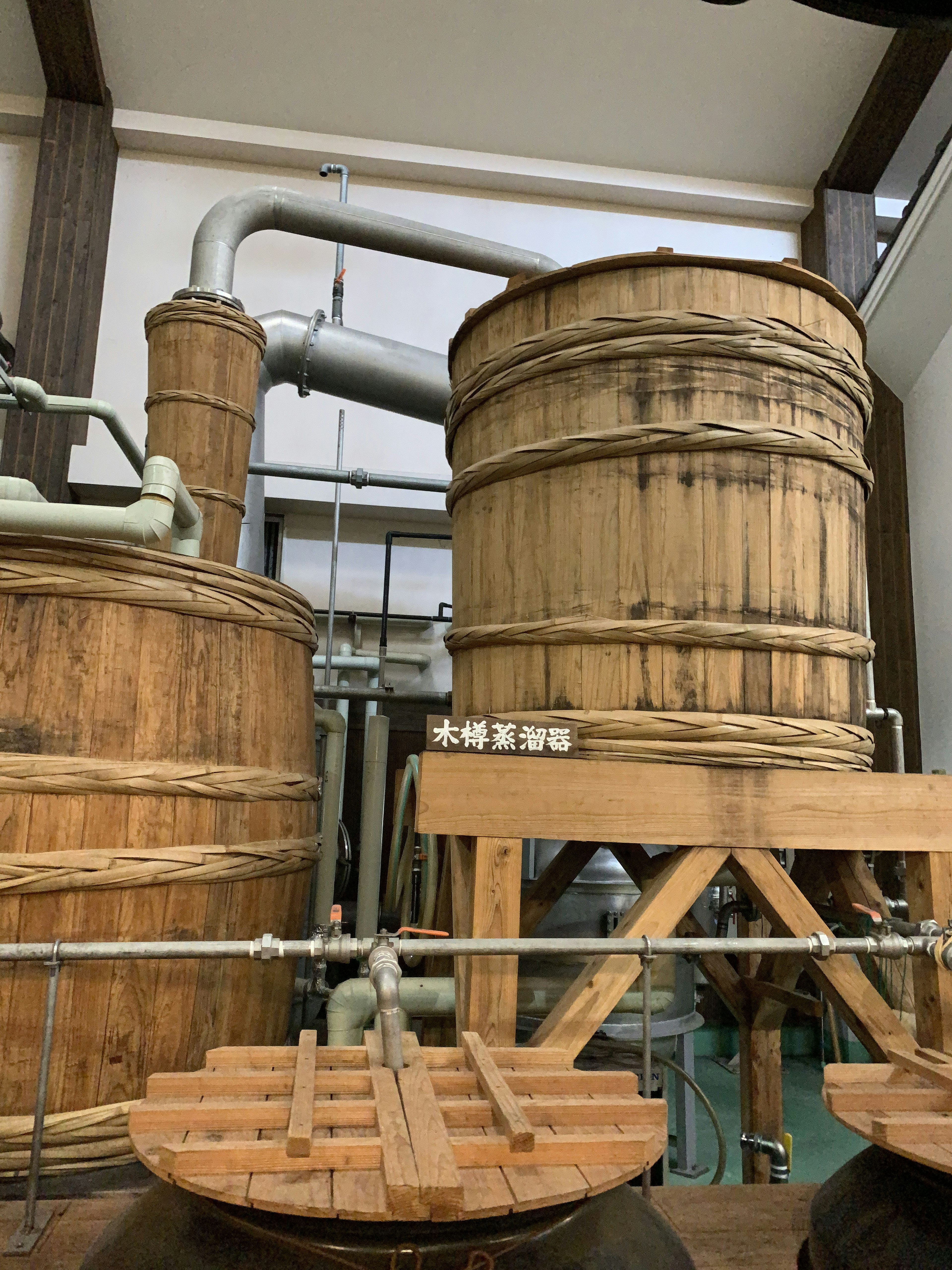 Traditional brewing equipment featuring wooden tanks and pipes