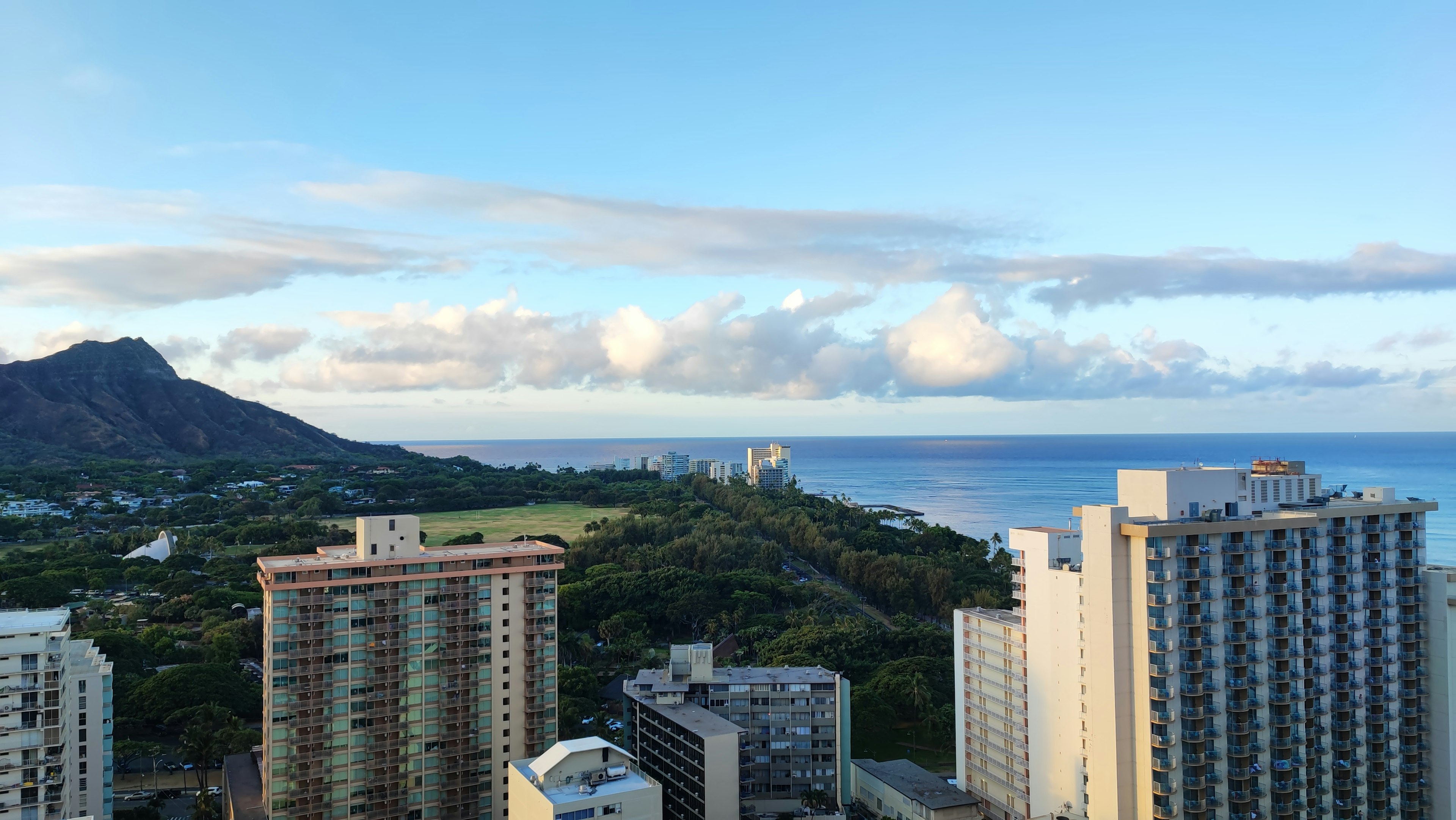 Blick auf die Wolkenkratzer von Honolulu mit Diamond Head im Hintergrund und blauem Ozean