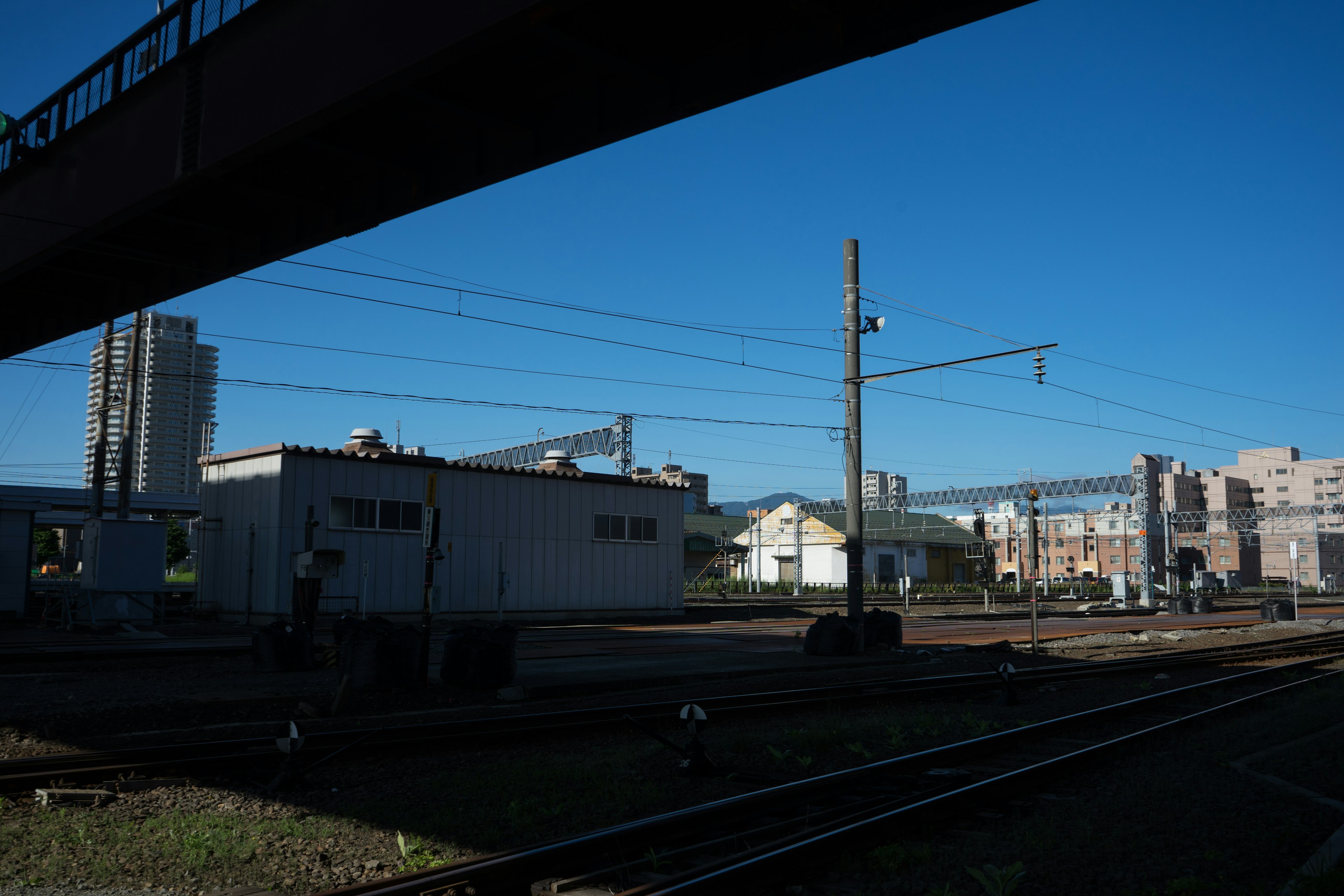 Railway scene with buildings under a blue sky