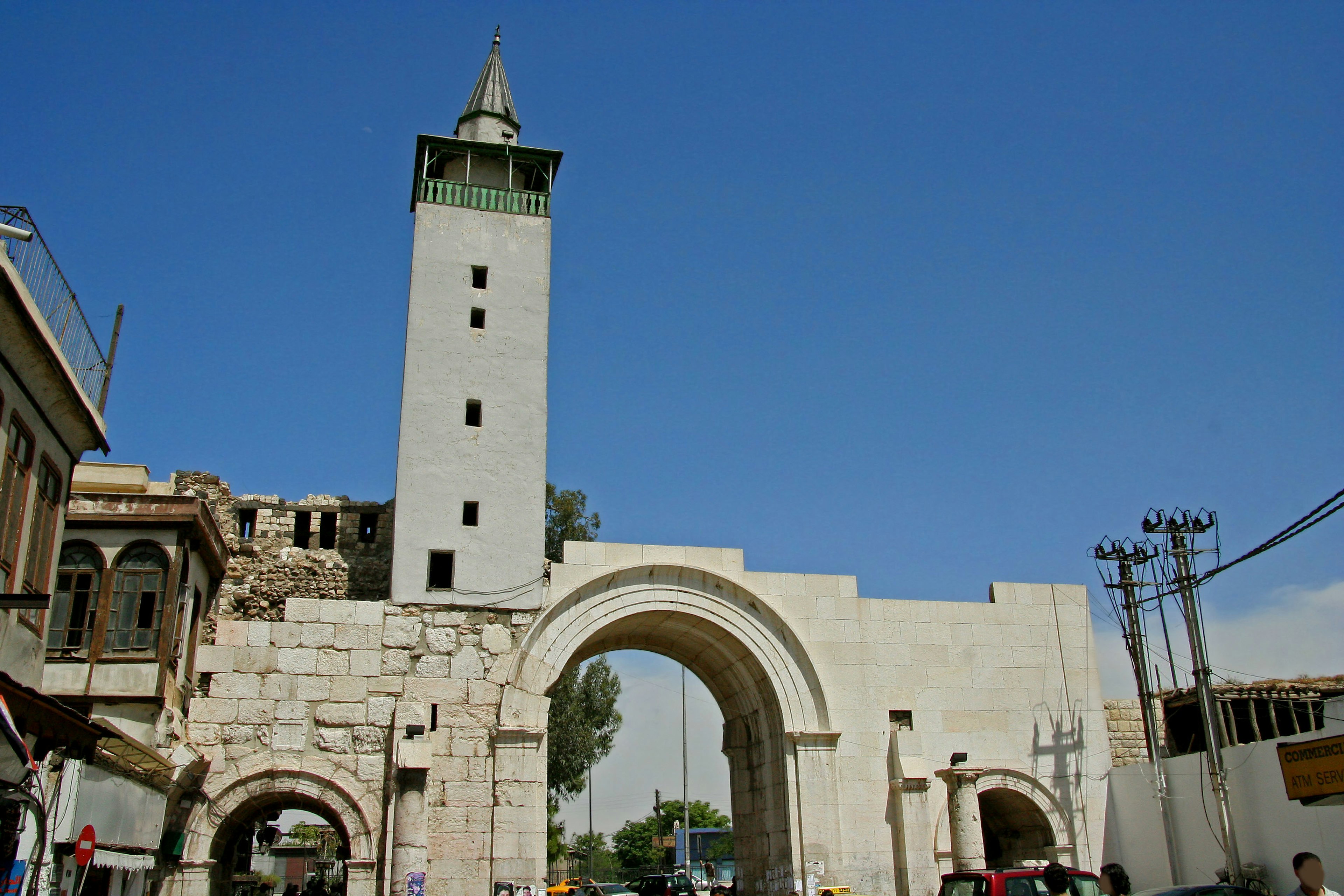 Historic gate and tower in Damascus under a clear blue sky