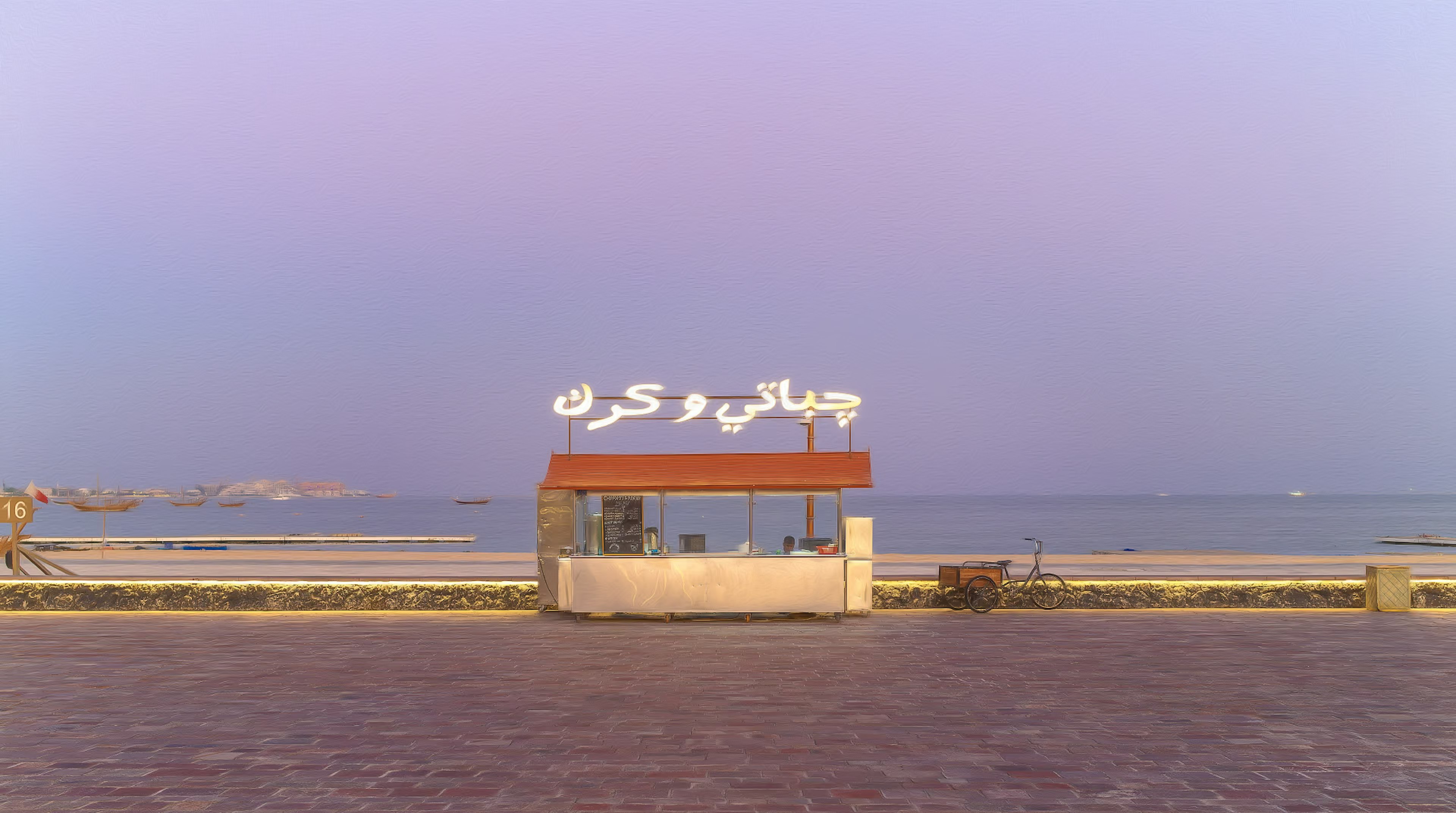 Sign in front of a building facing the sea