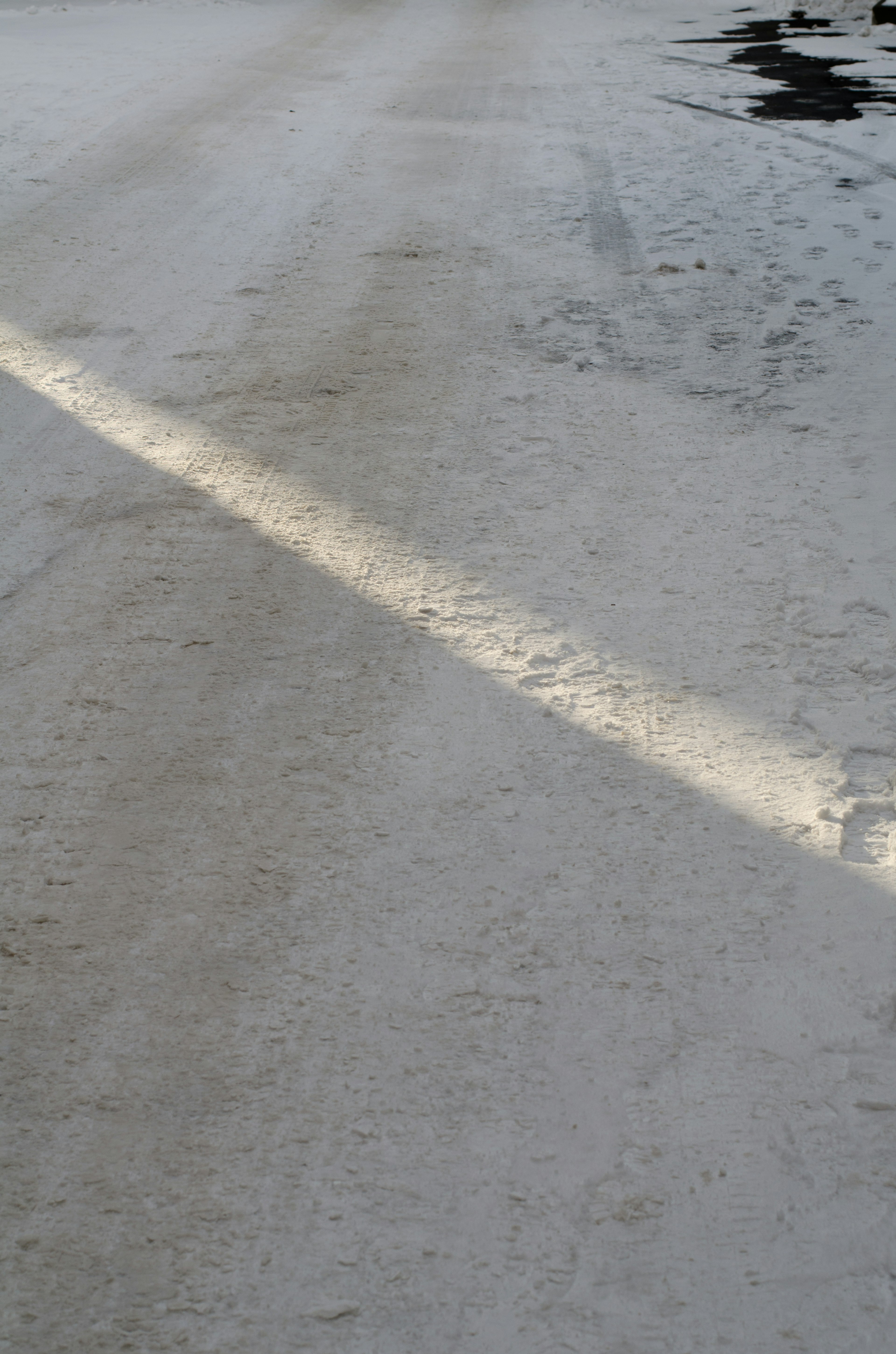 Snow-covered road with a beam of light