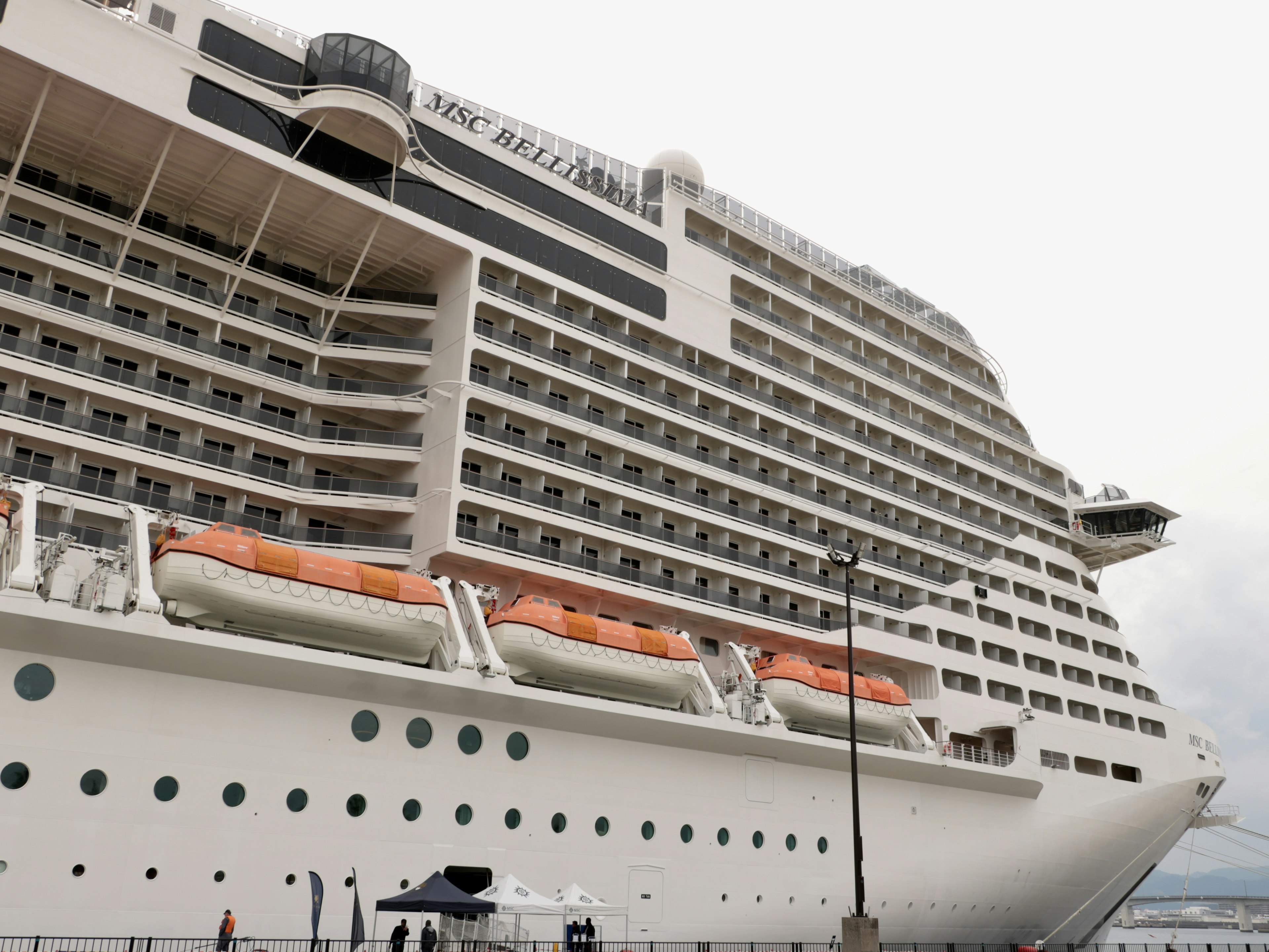 Image of a large cruise ship showcasing its building-like design and lifeboats