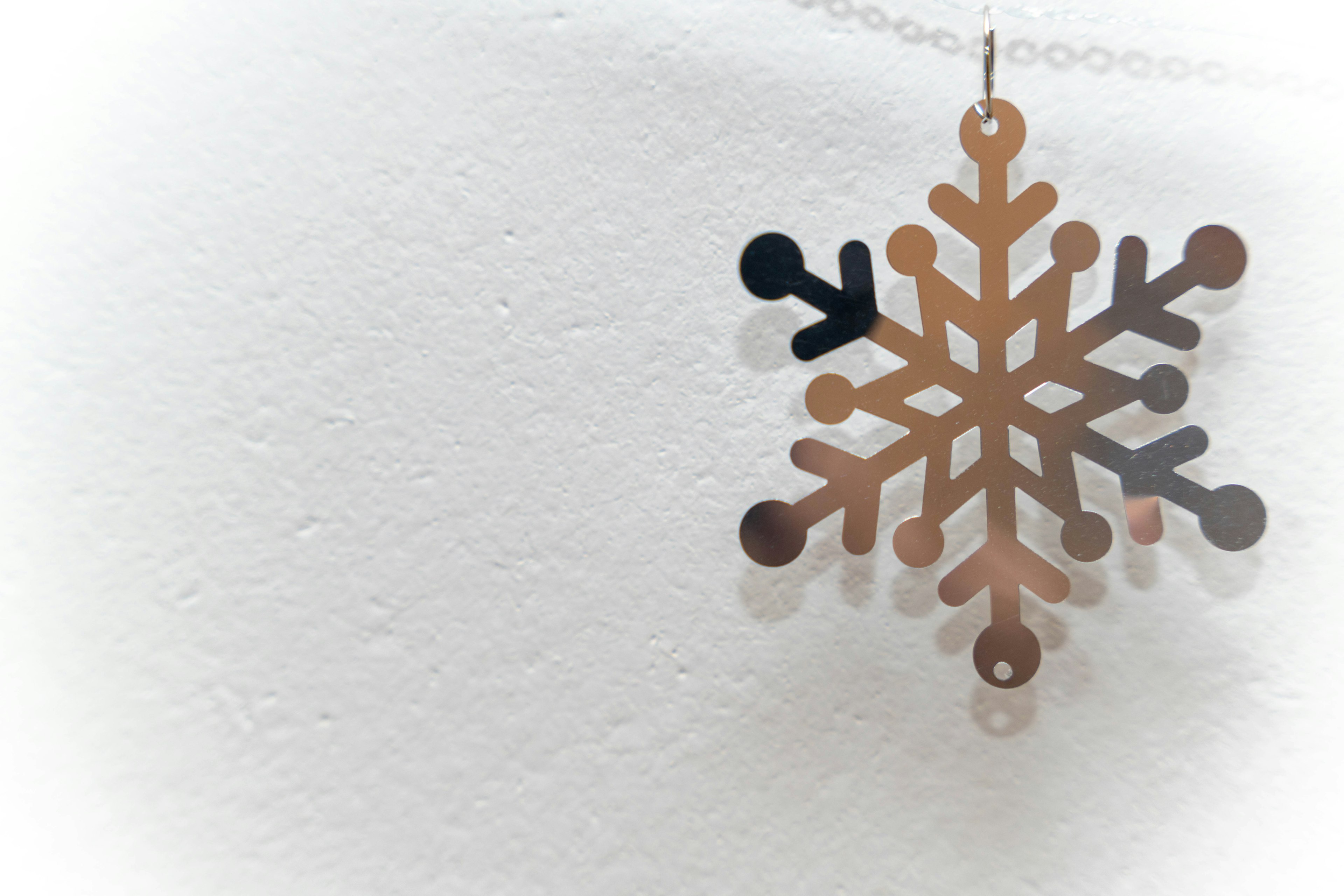 Gold snowflake decoration hanging on a wall