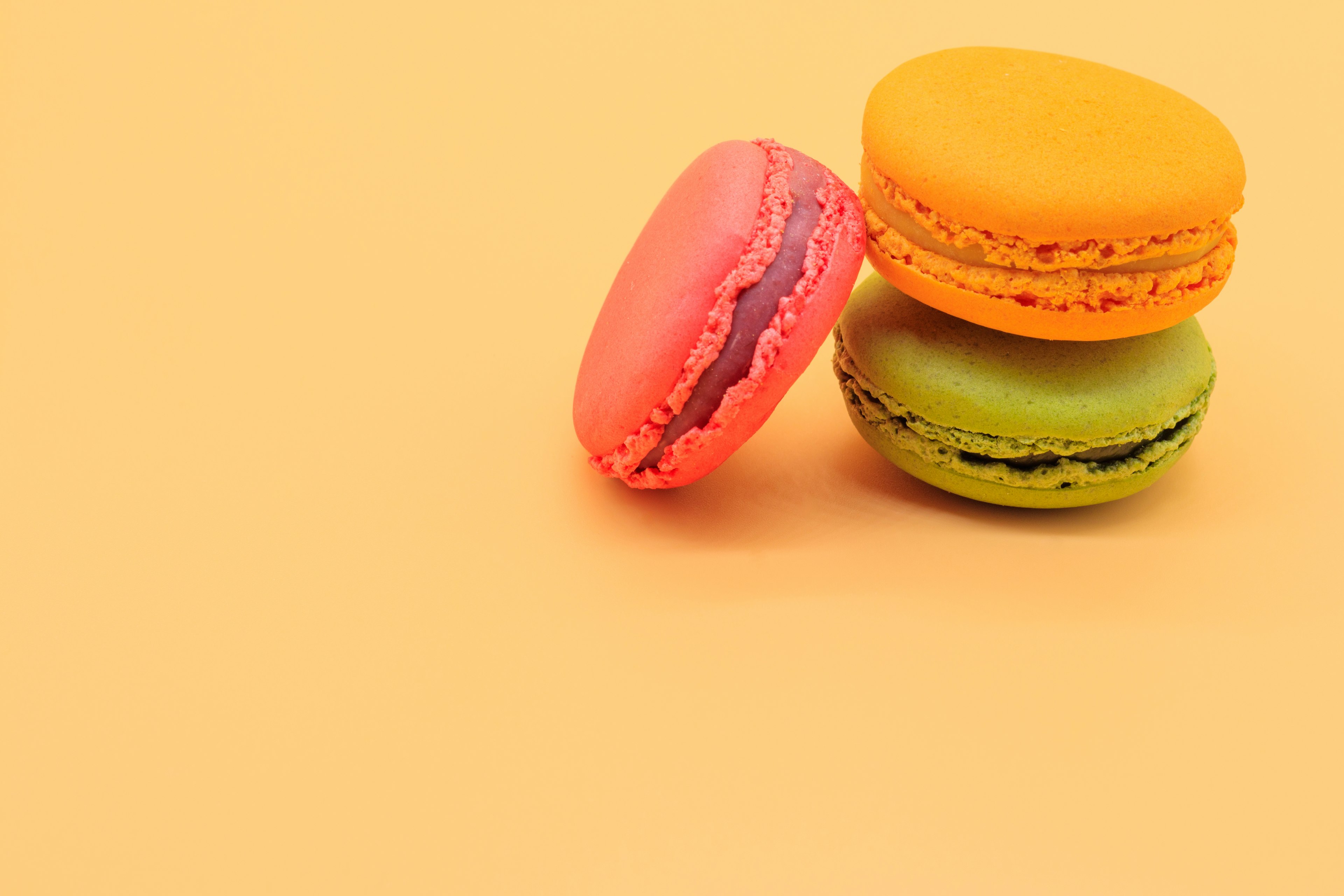 Colorful macarons on an orange background