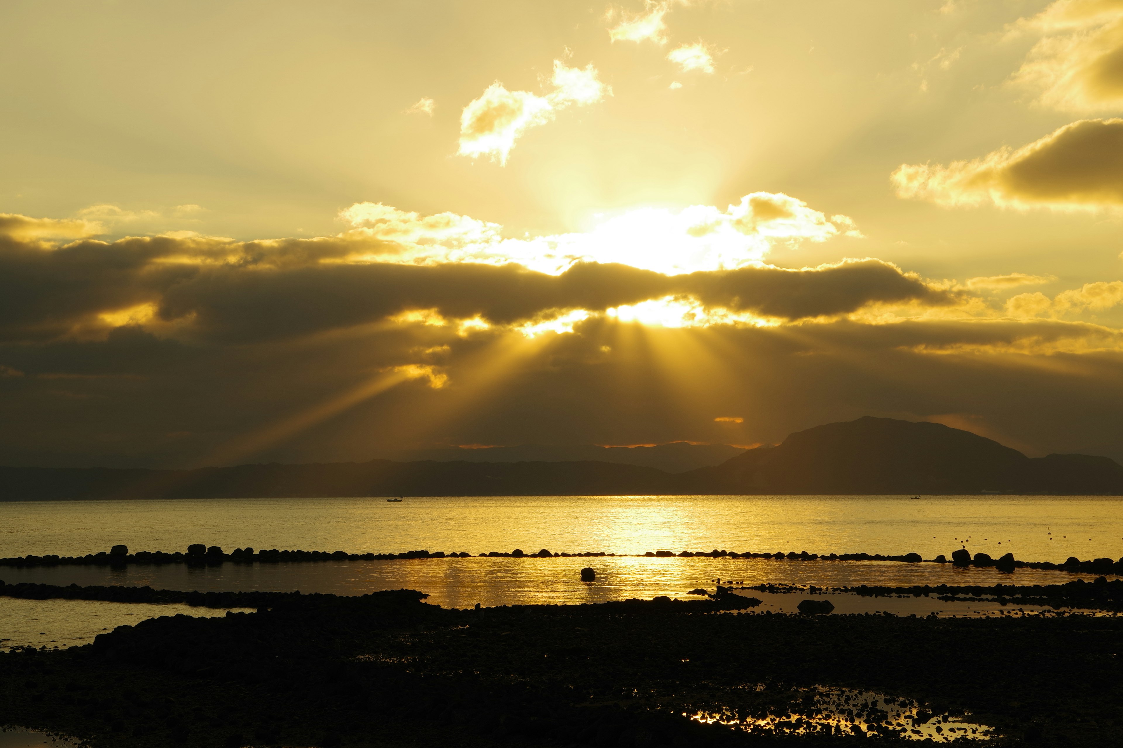 Beautiful landscape with sunset rays breaking through clouds