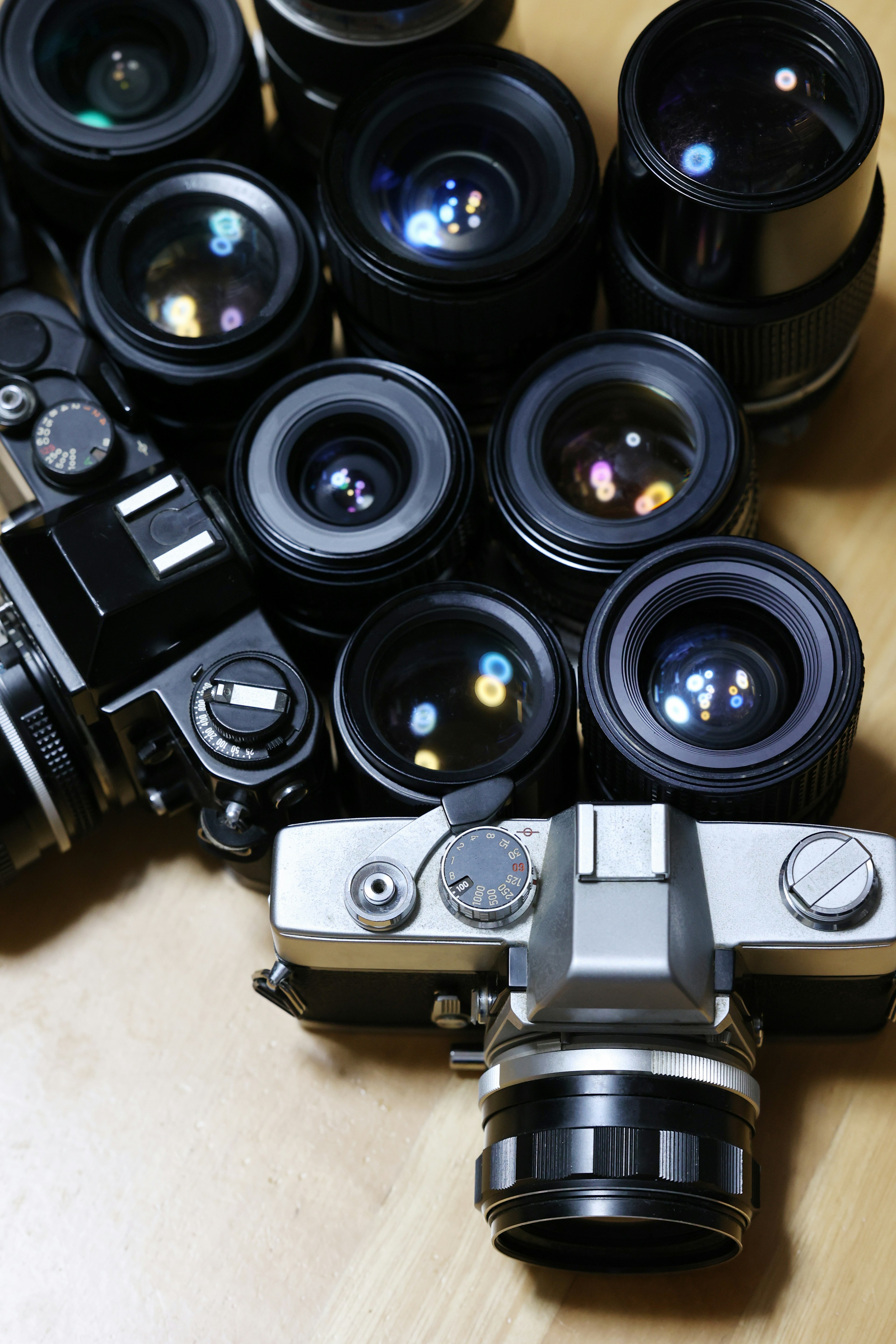 A collection of cameras and lenses arranged together