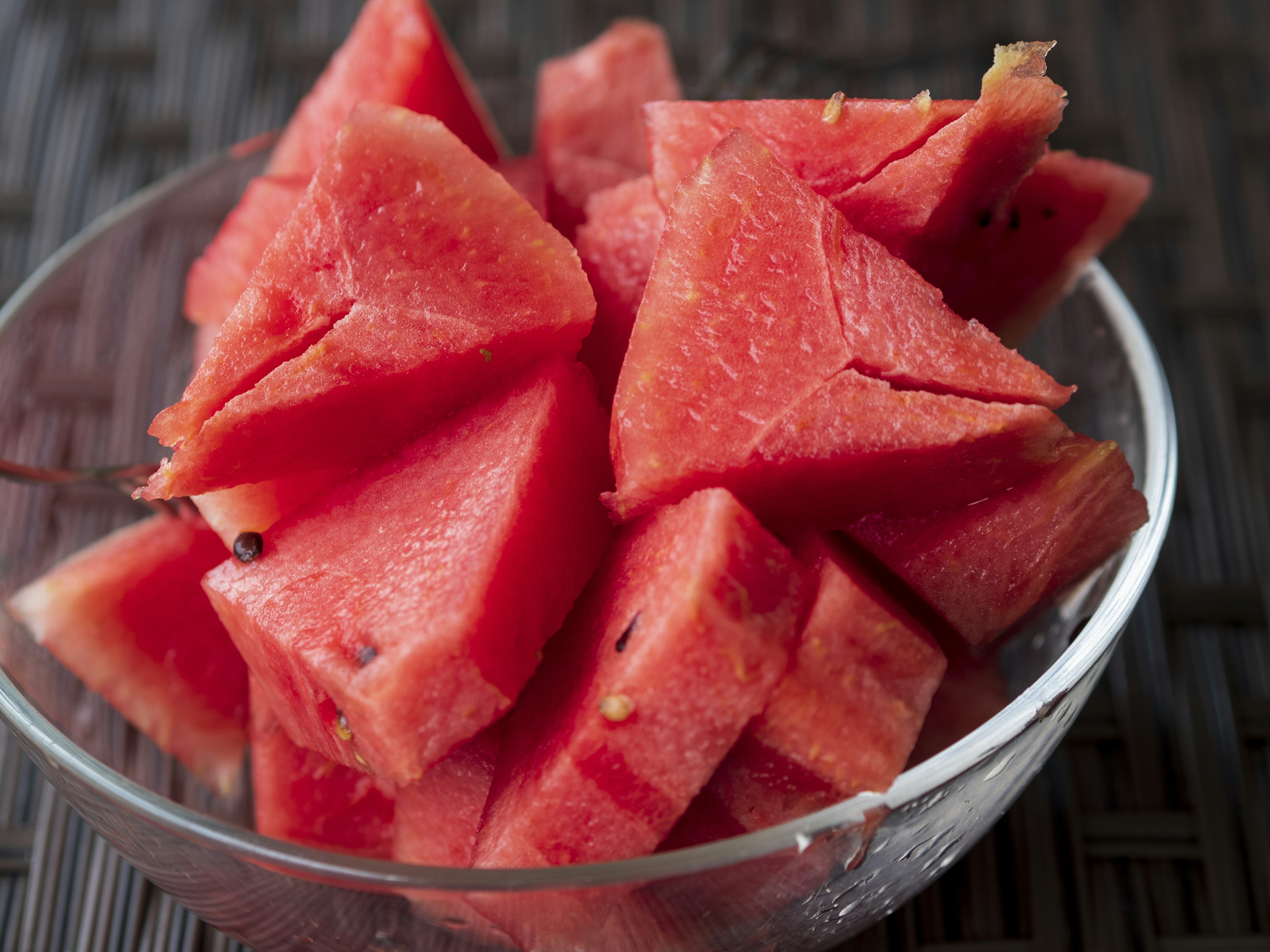 Triangular pieces of watermelon in a clear bowl