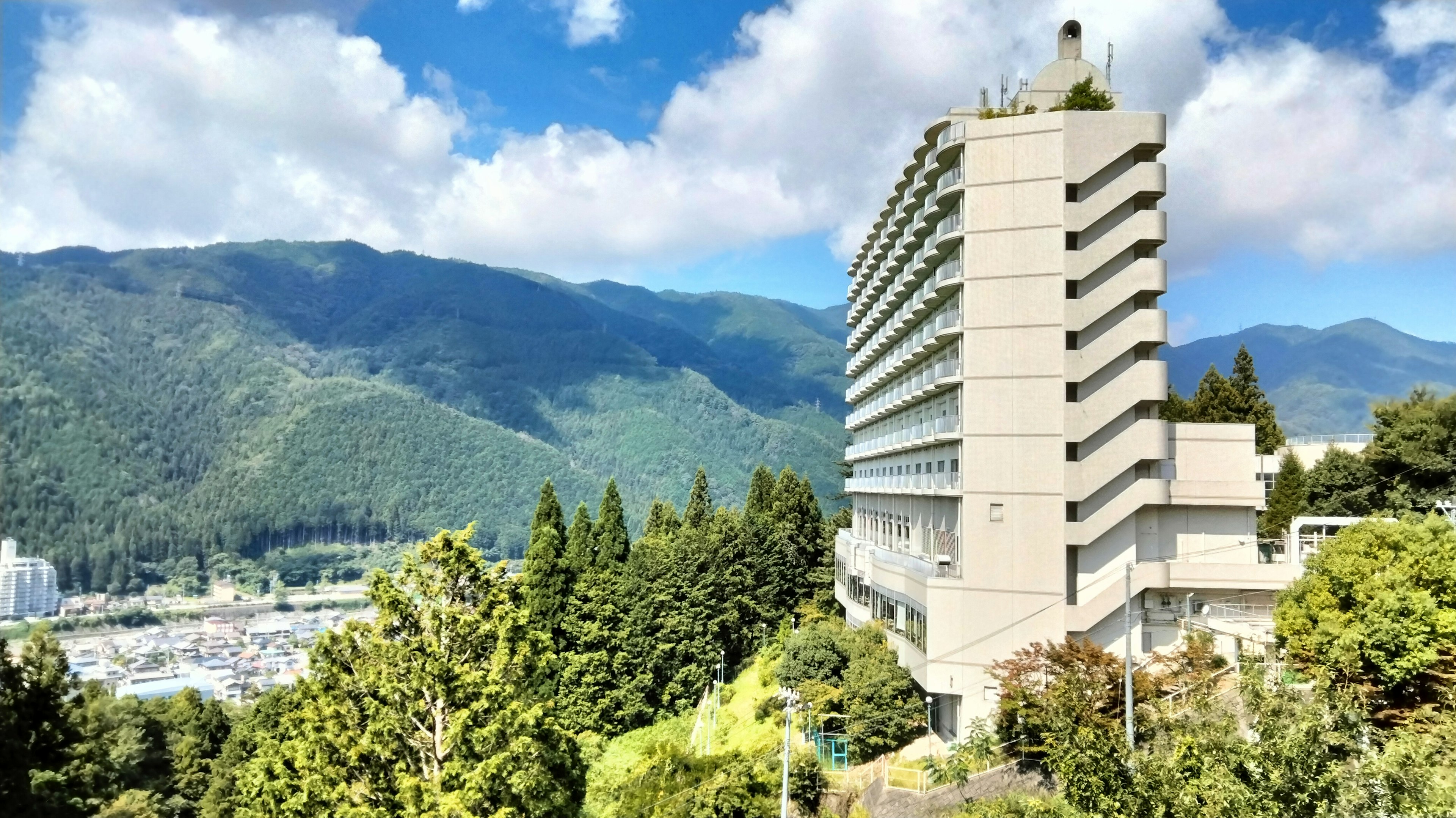 Modern building surrounded by mountains and blue sky