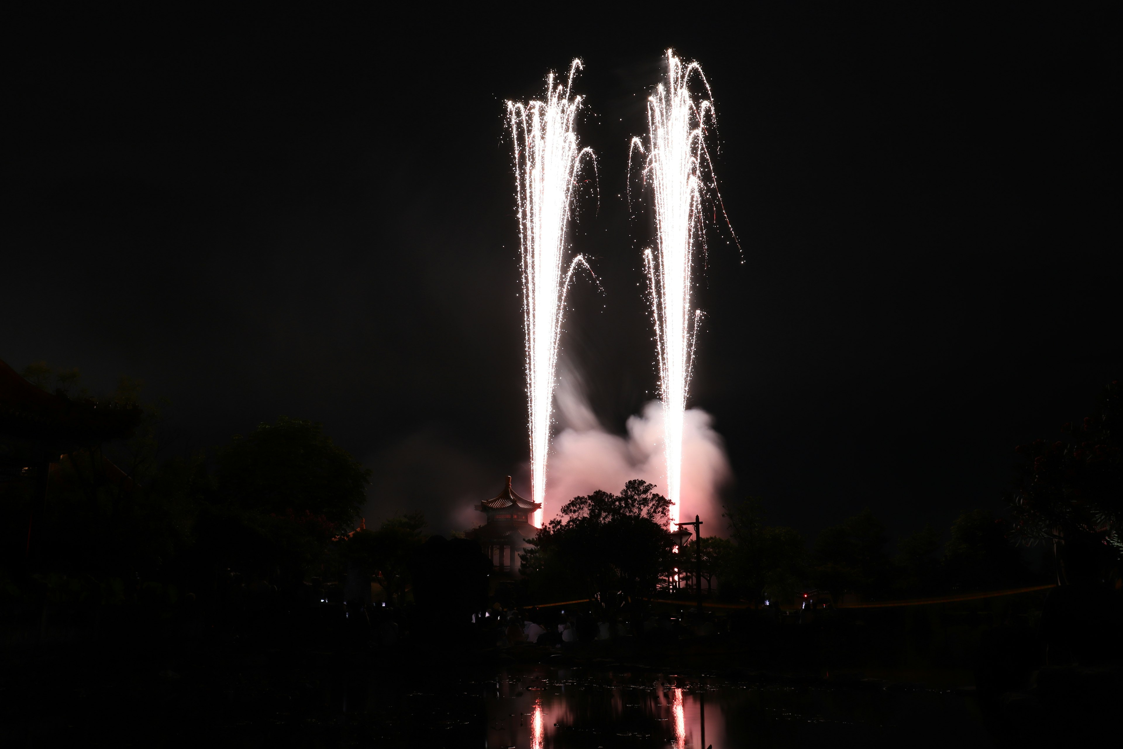 Two fountains of fireworks lighting up the night sky