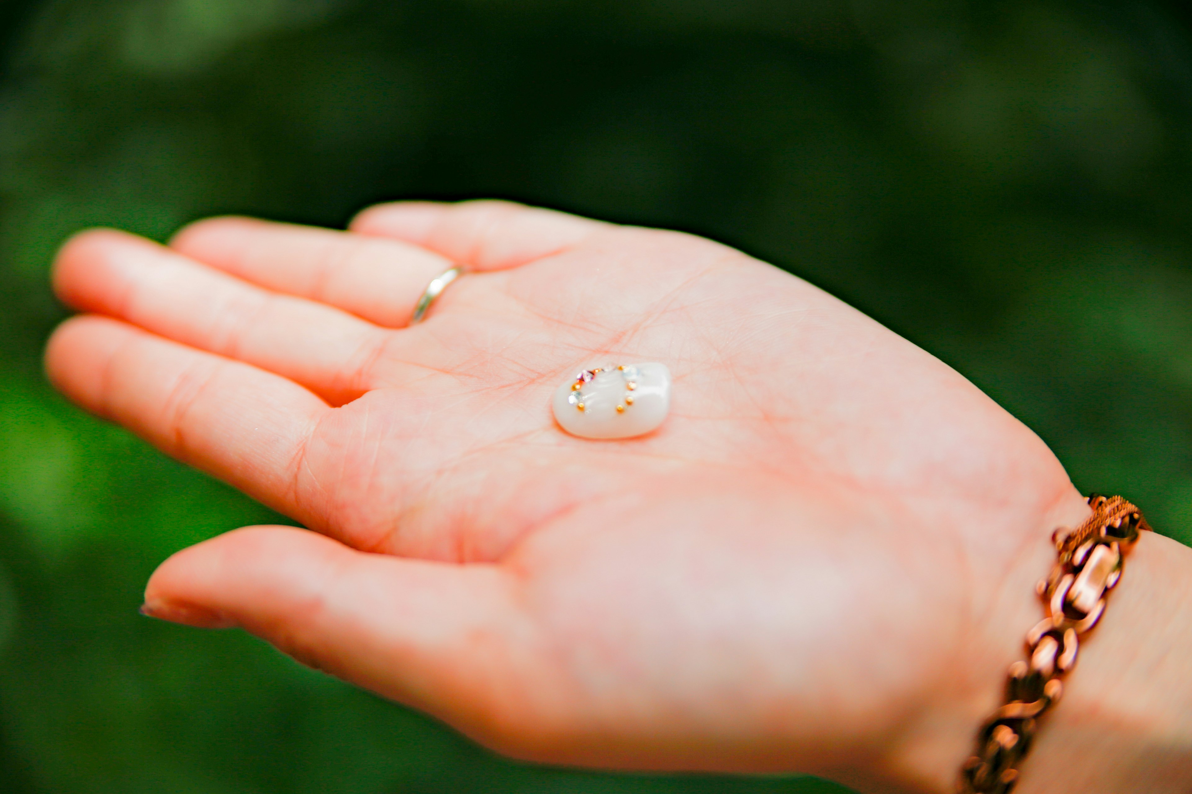 A clear stone resting on an open palm