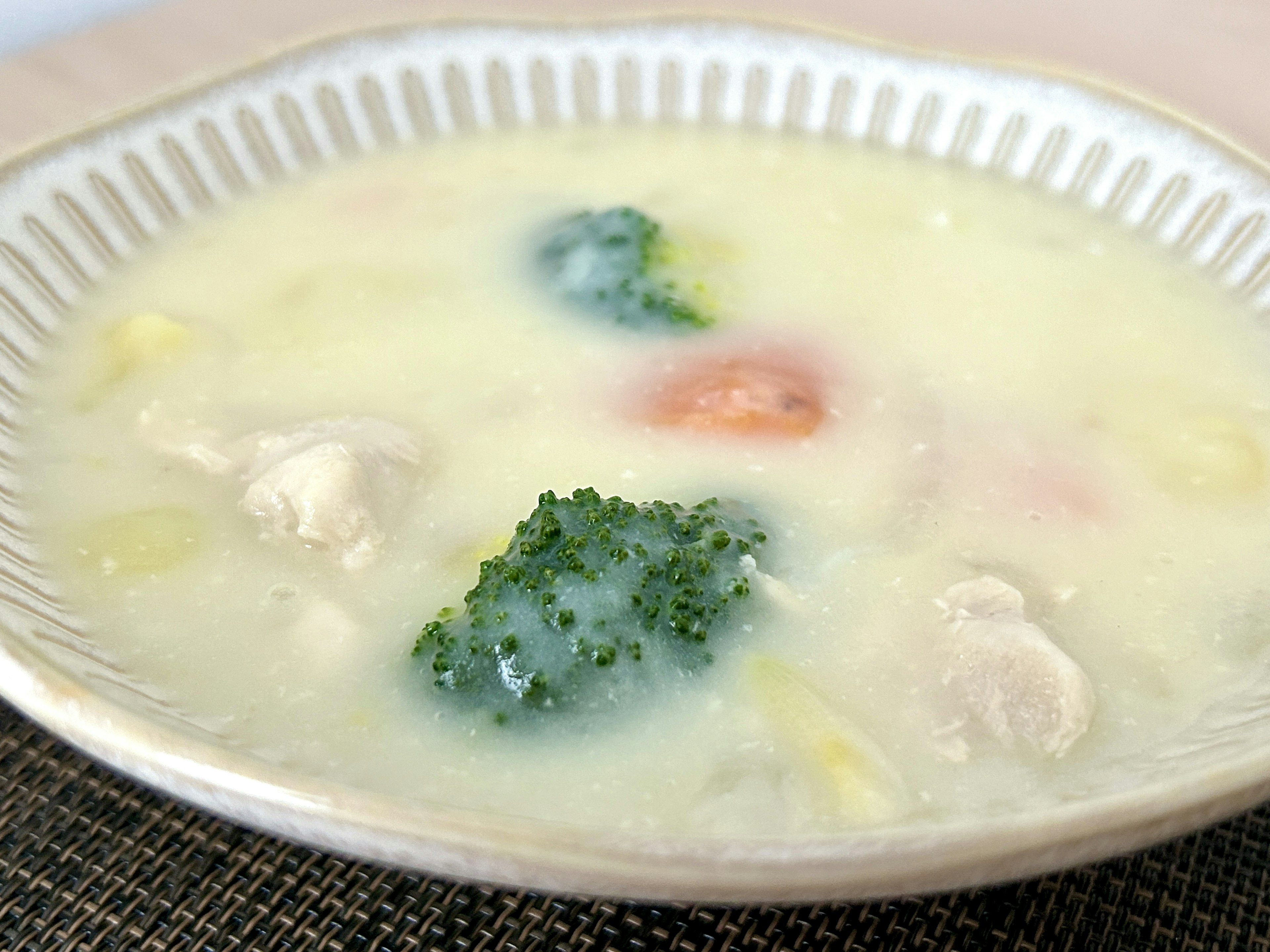 Creamy soup with broccoli and chunks of chicken