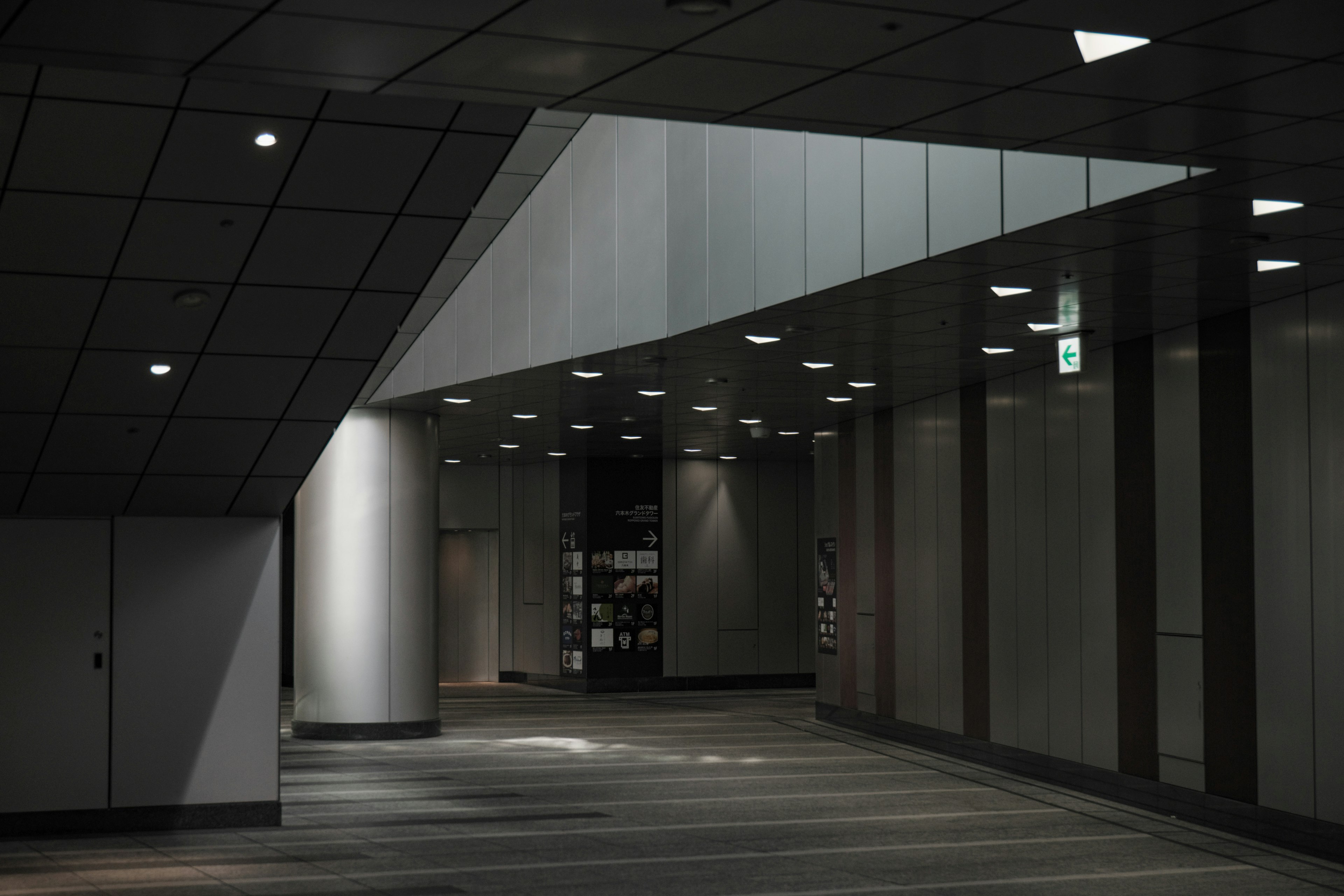 Modern interior corridor with angled ceiling and ambient lighting