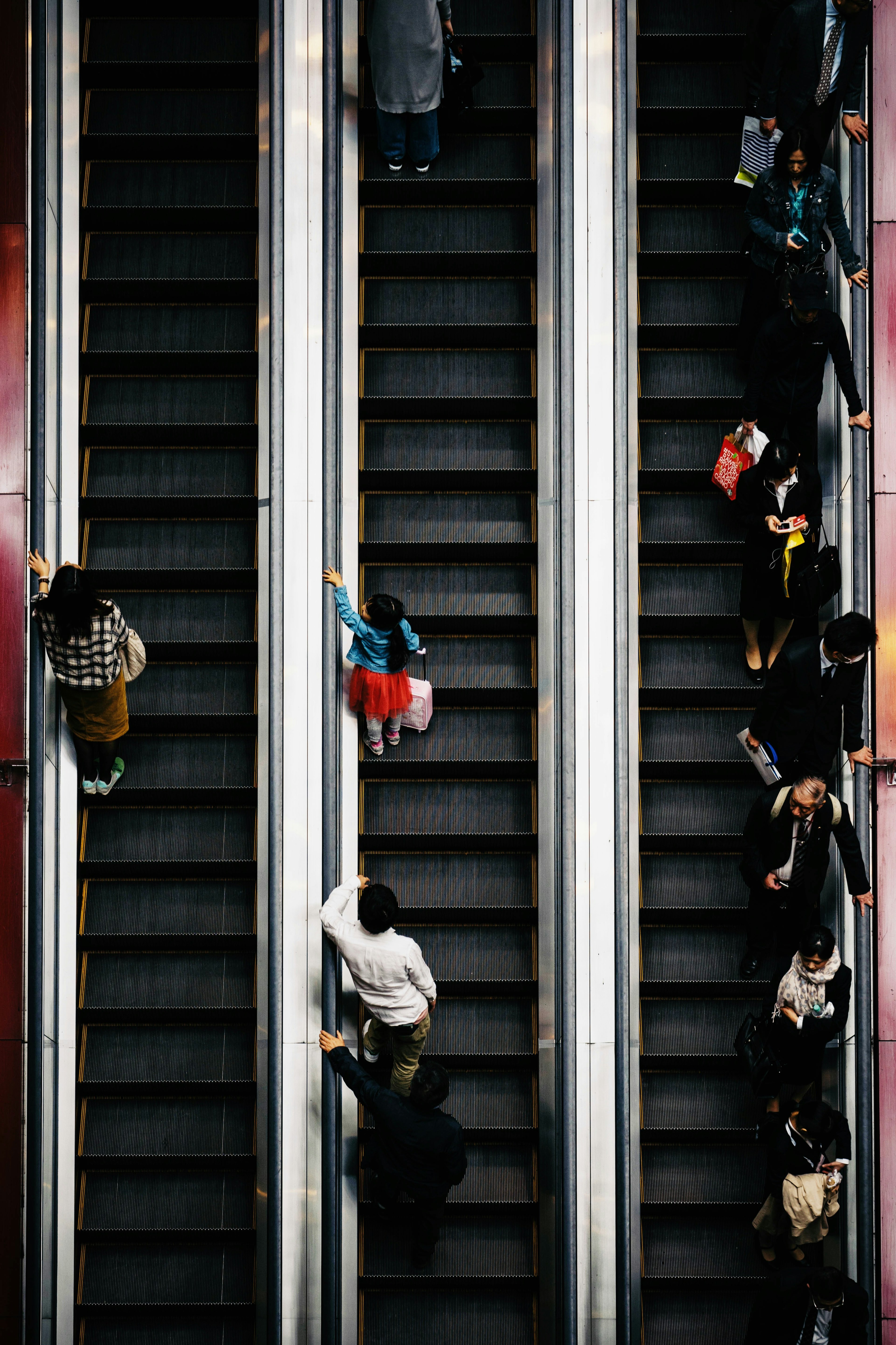 Aerial view of people using escalators in a busy environment