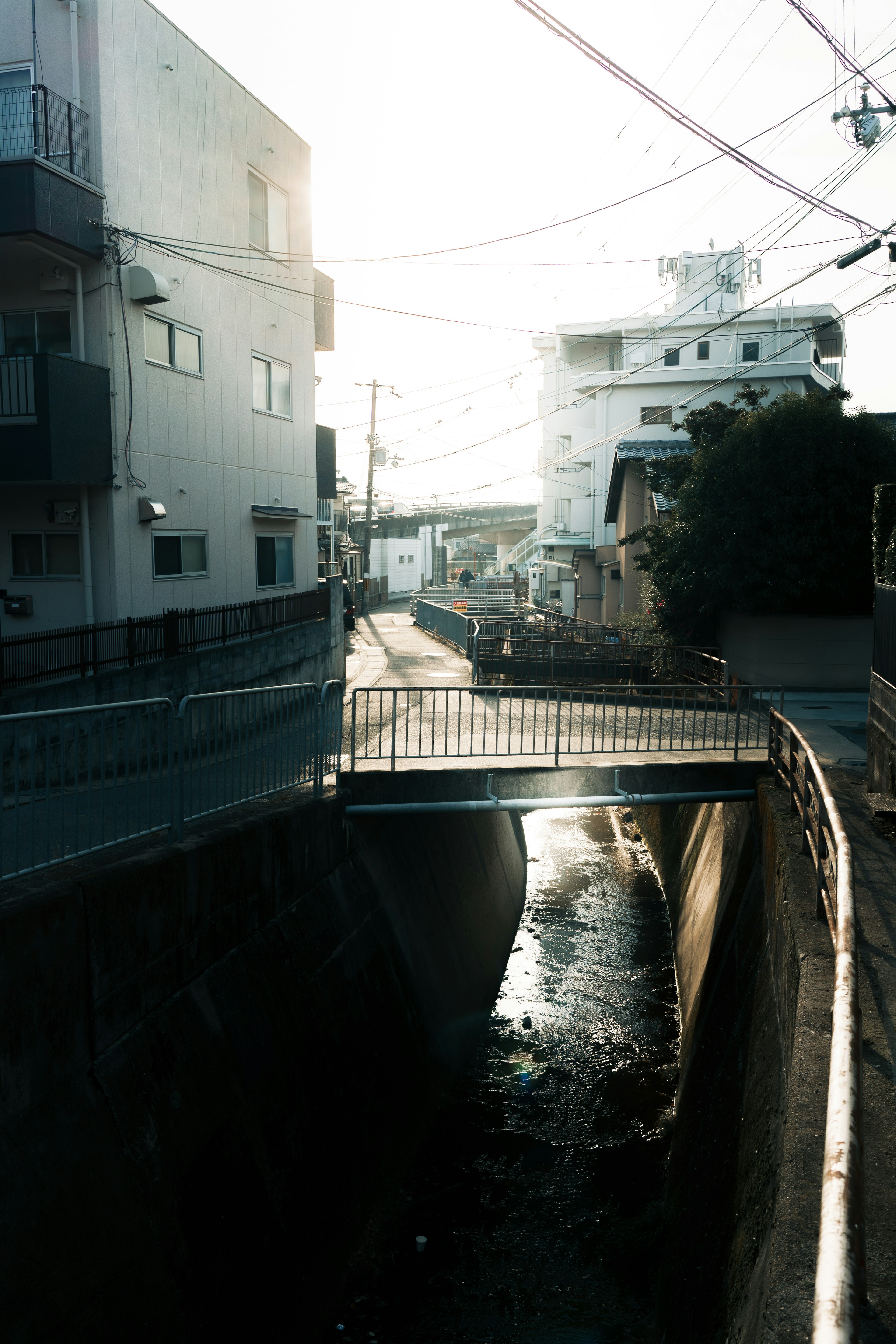 Narrow waterway with a bridge and surrounding buildings