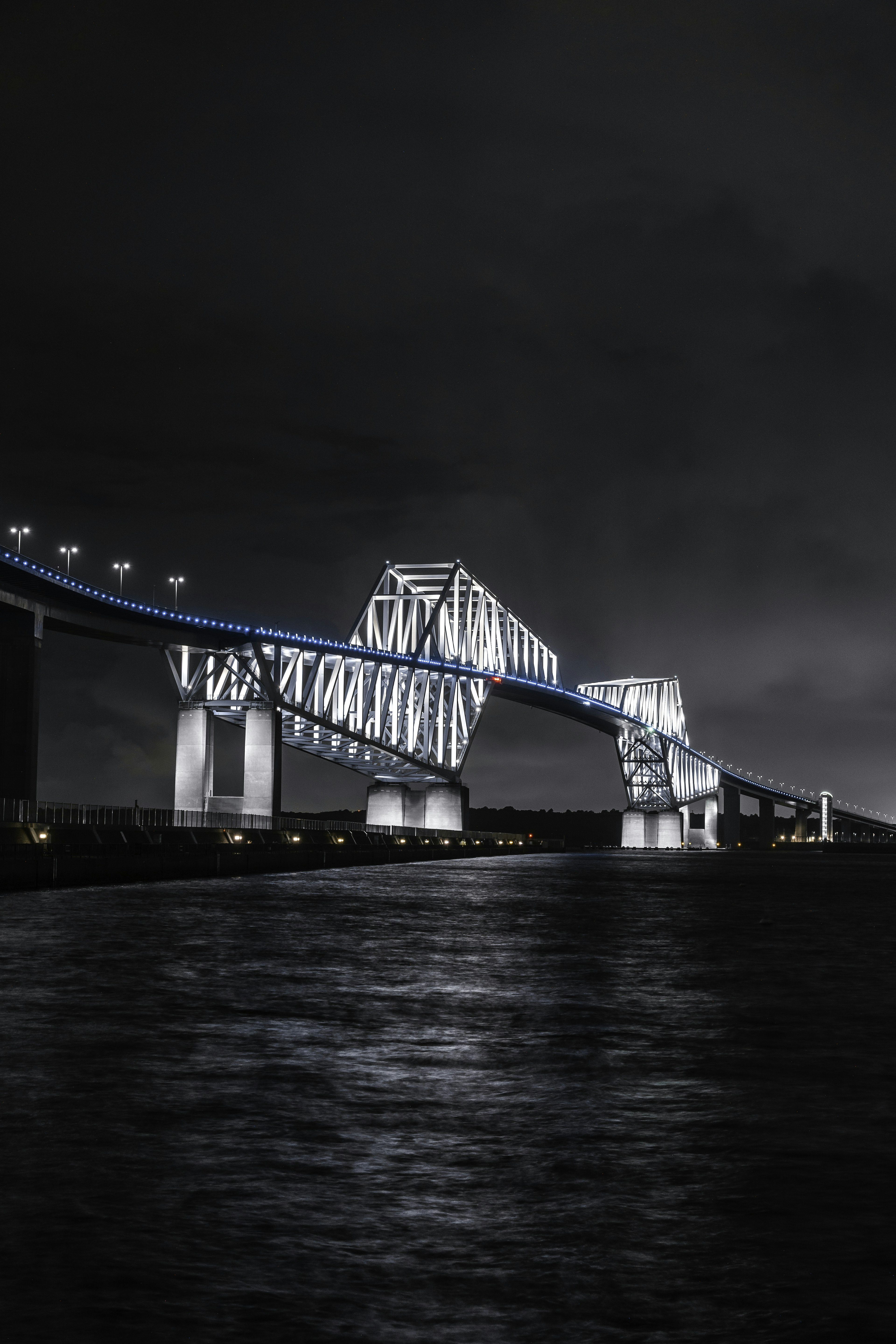 Beautiful bridge structure reflected on the water at night