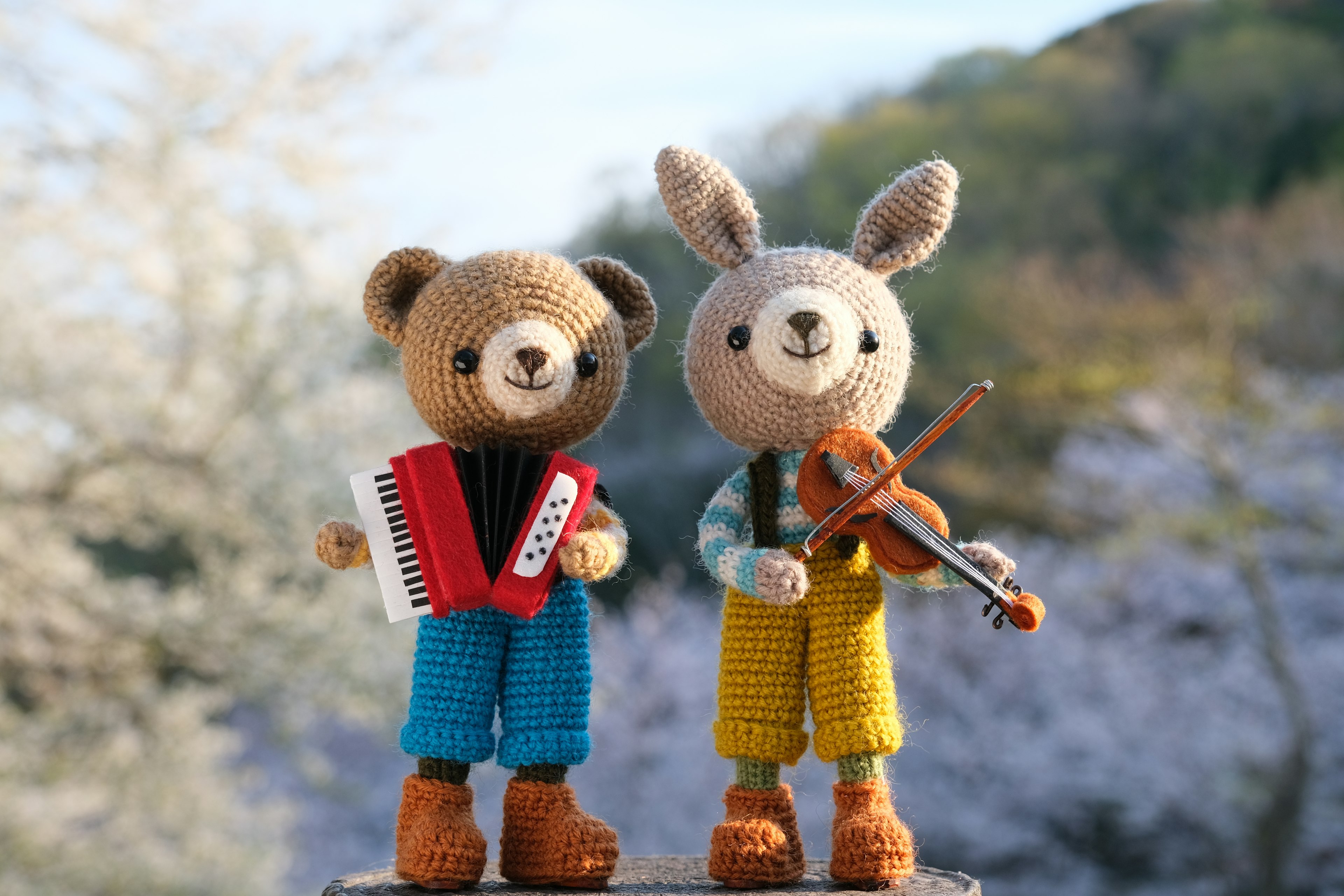 Cute teddy bear and rabbit plush toys holding musical instruments