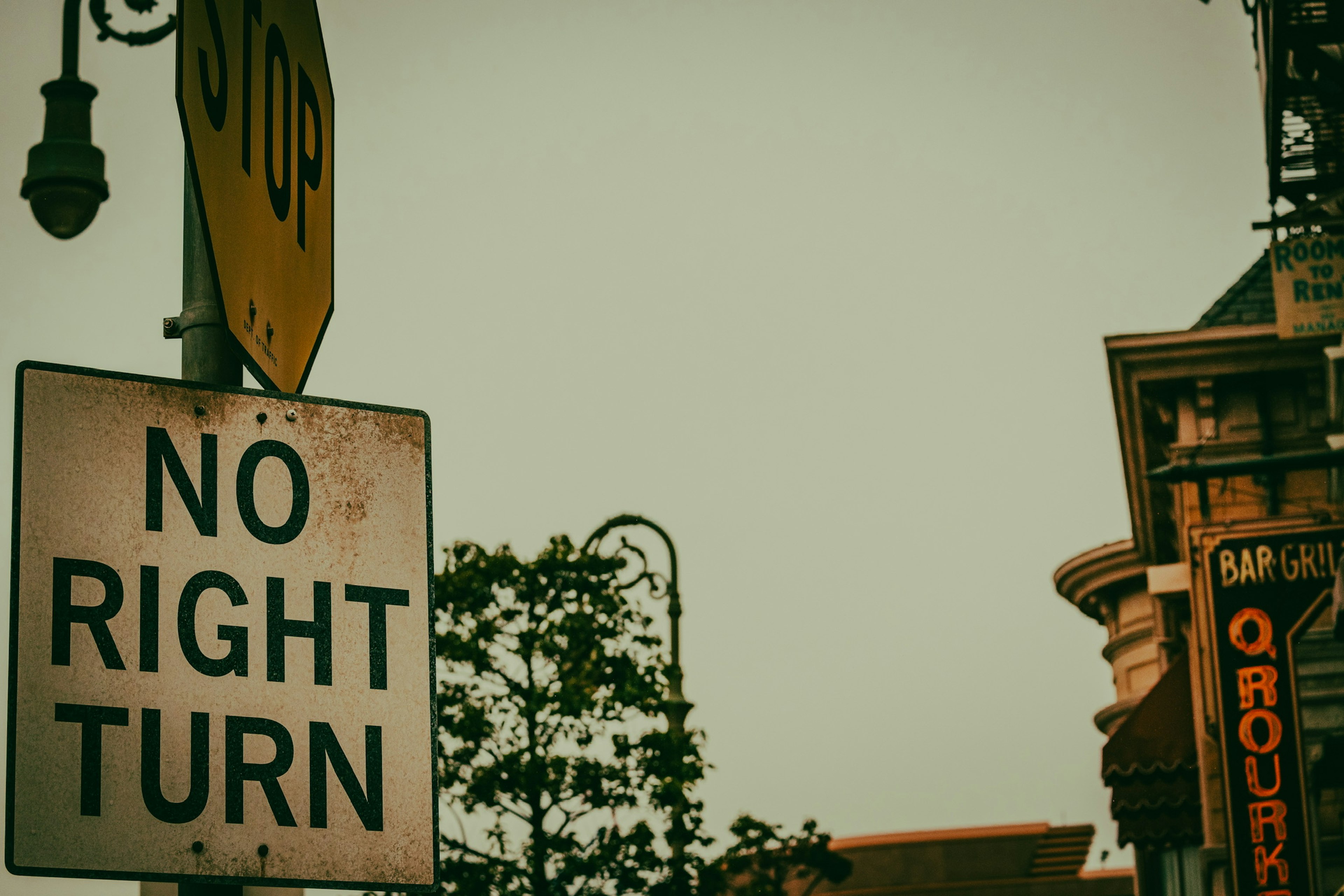 A traffic sign displaying 'No Right Turn' with a stop sign in the background