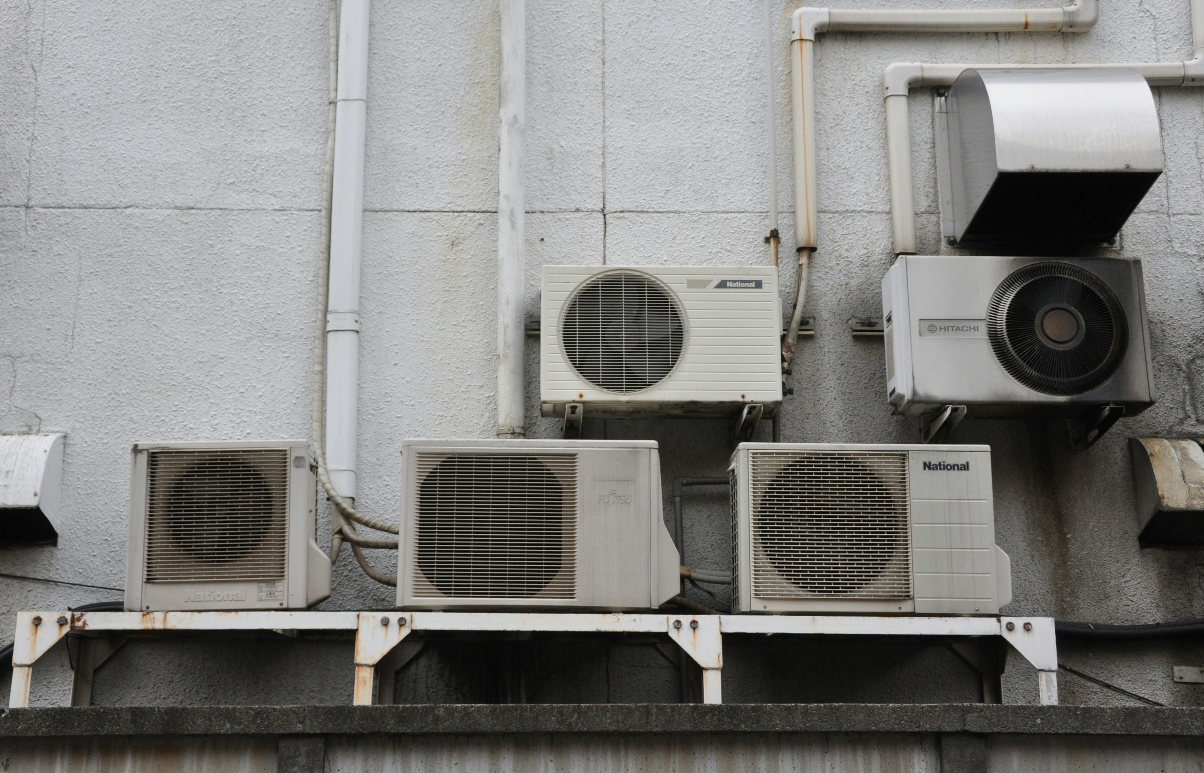 Multiple air conditioning units mounted on a wall