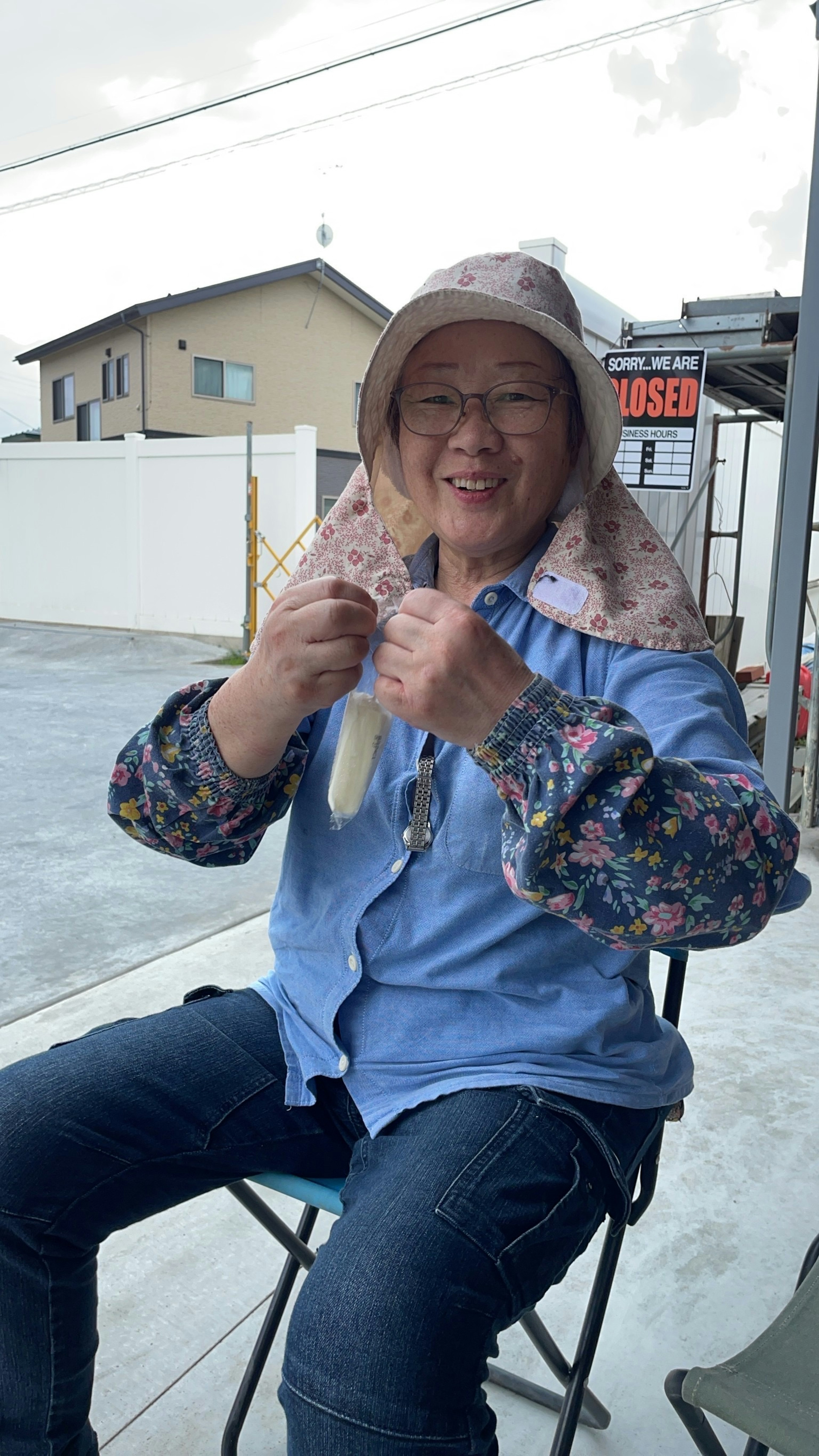 A woman wearing a hat sitting on a chair