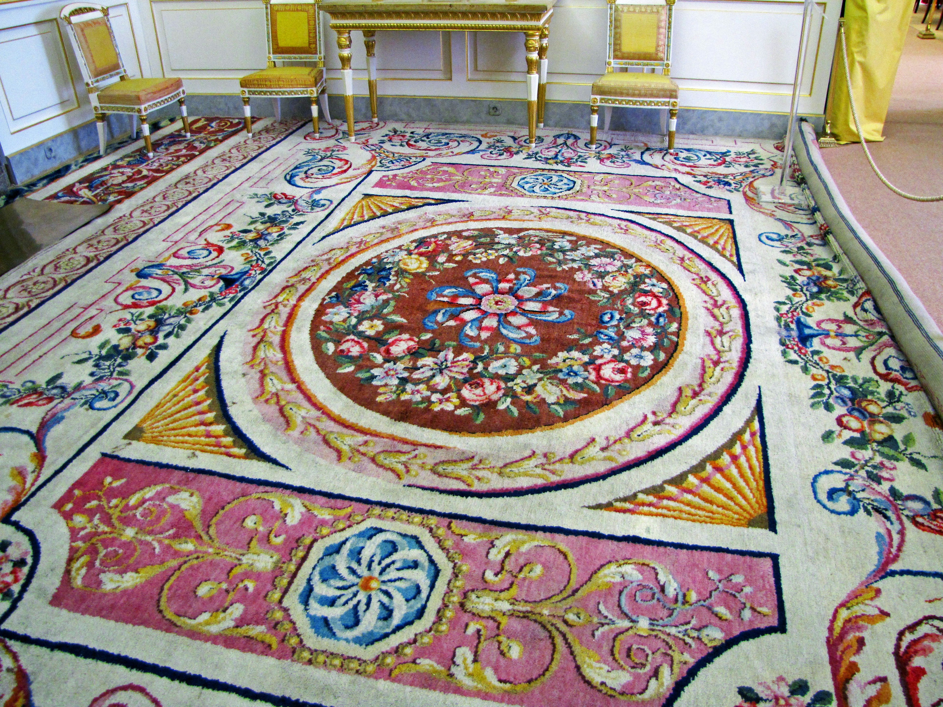 Intricate patterned carpet in an elegantly decorated room