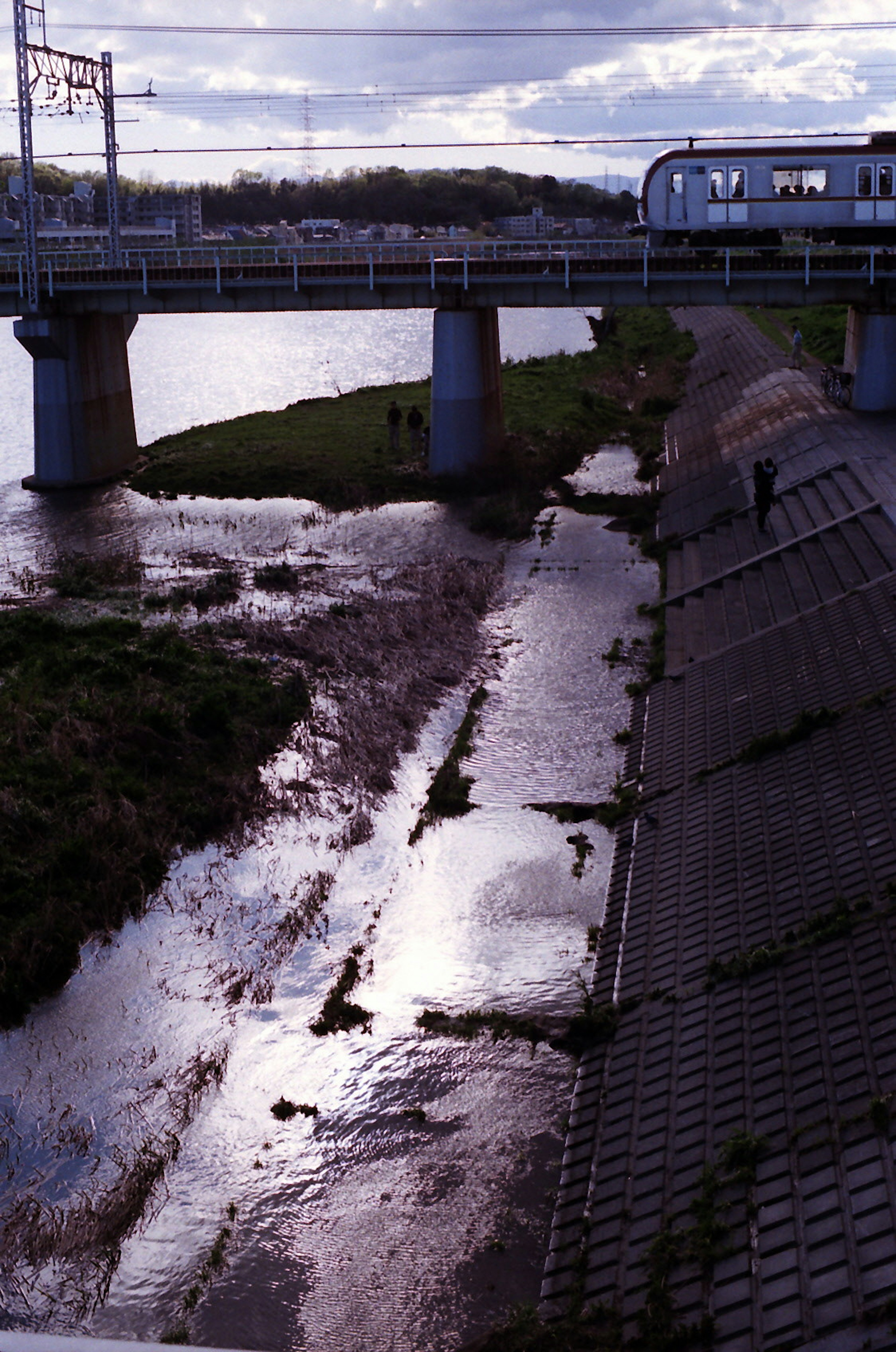 Scenic view of a river and bridge with a passing train