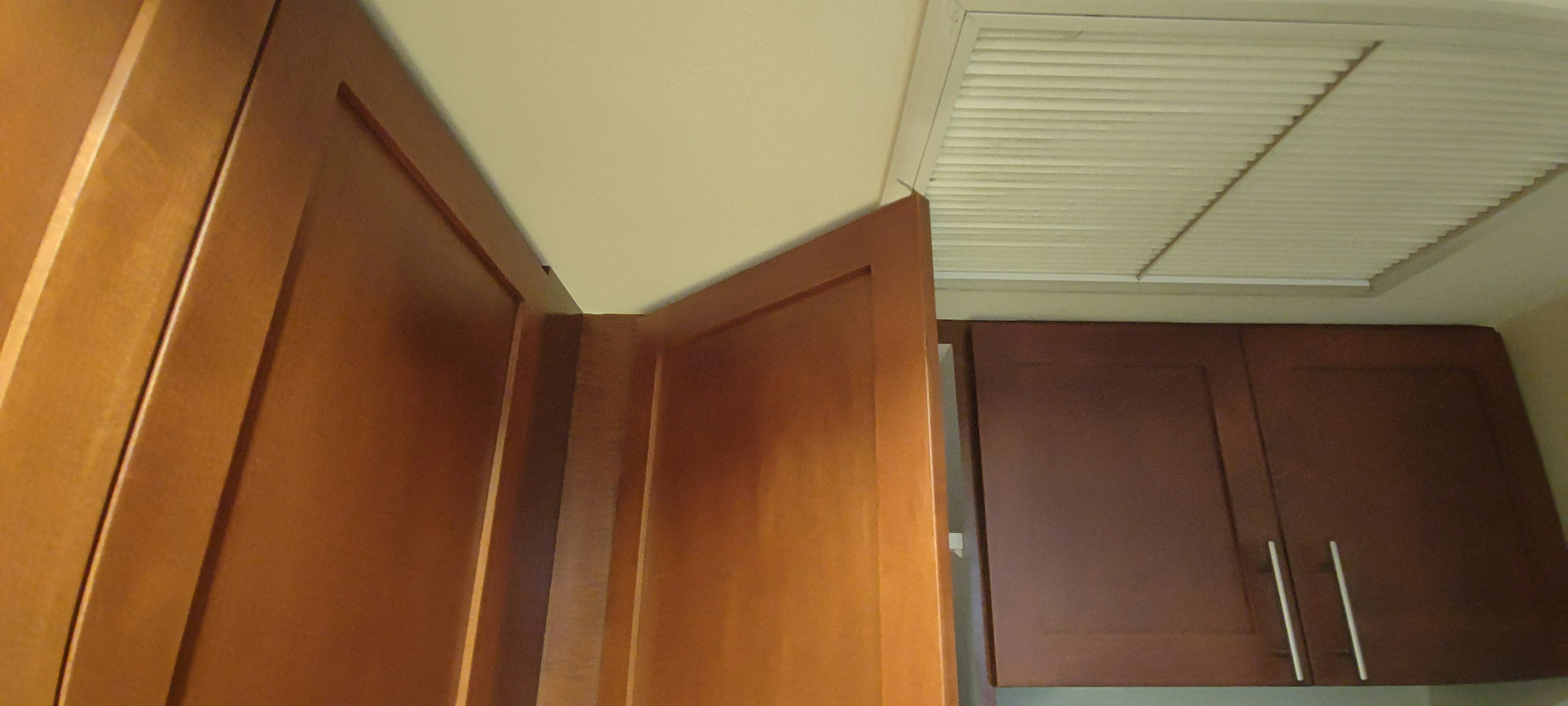 Image showing the corner of a wooden cabinet and part of the ceiling