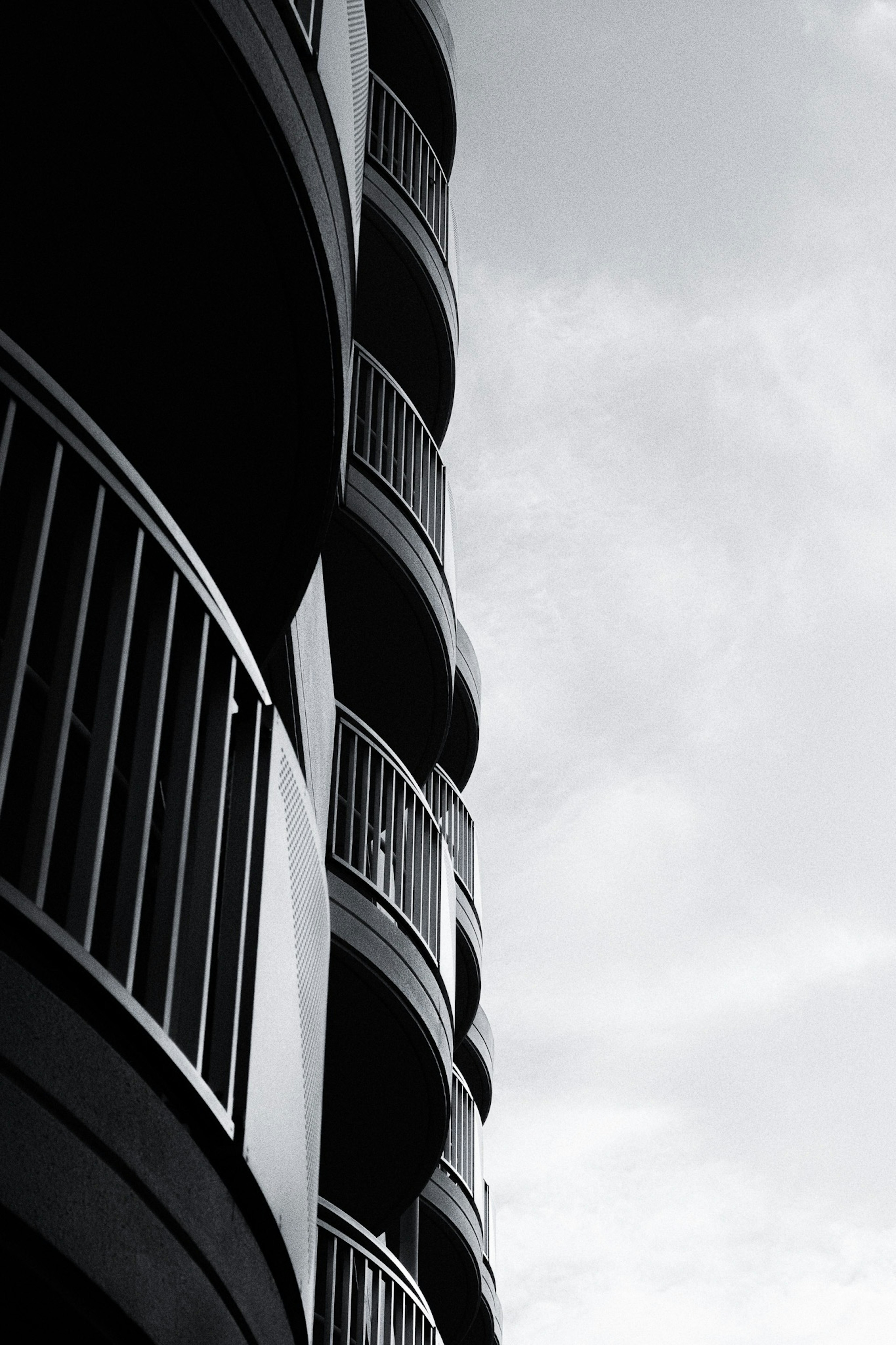 Black and white photo of a building with curved balconies