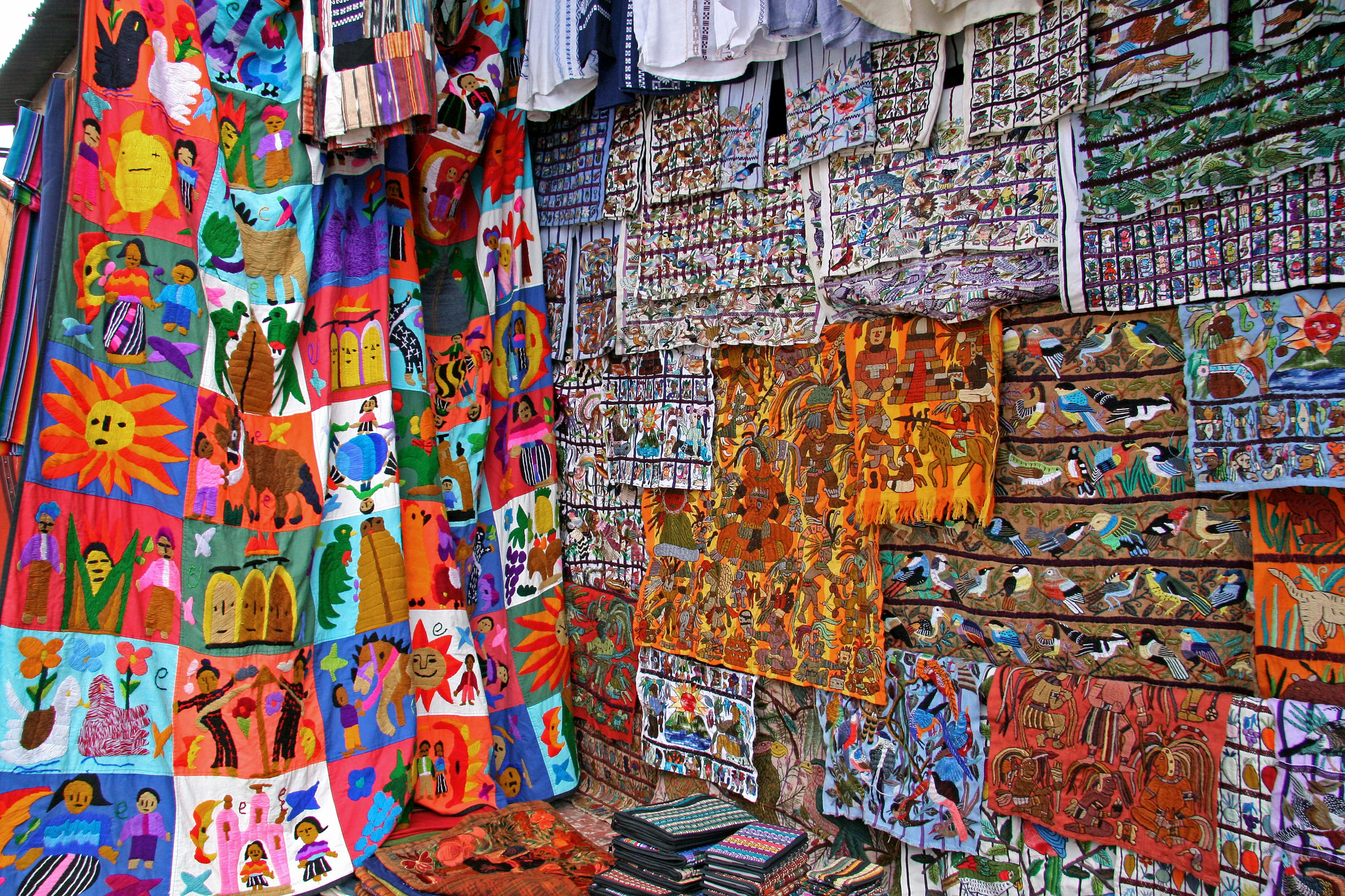 Colorful art pieces displayed on a wall showcasing various styles and color schemes