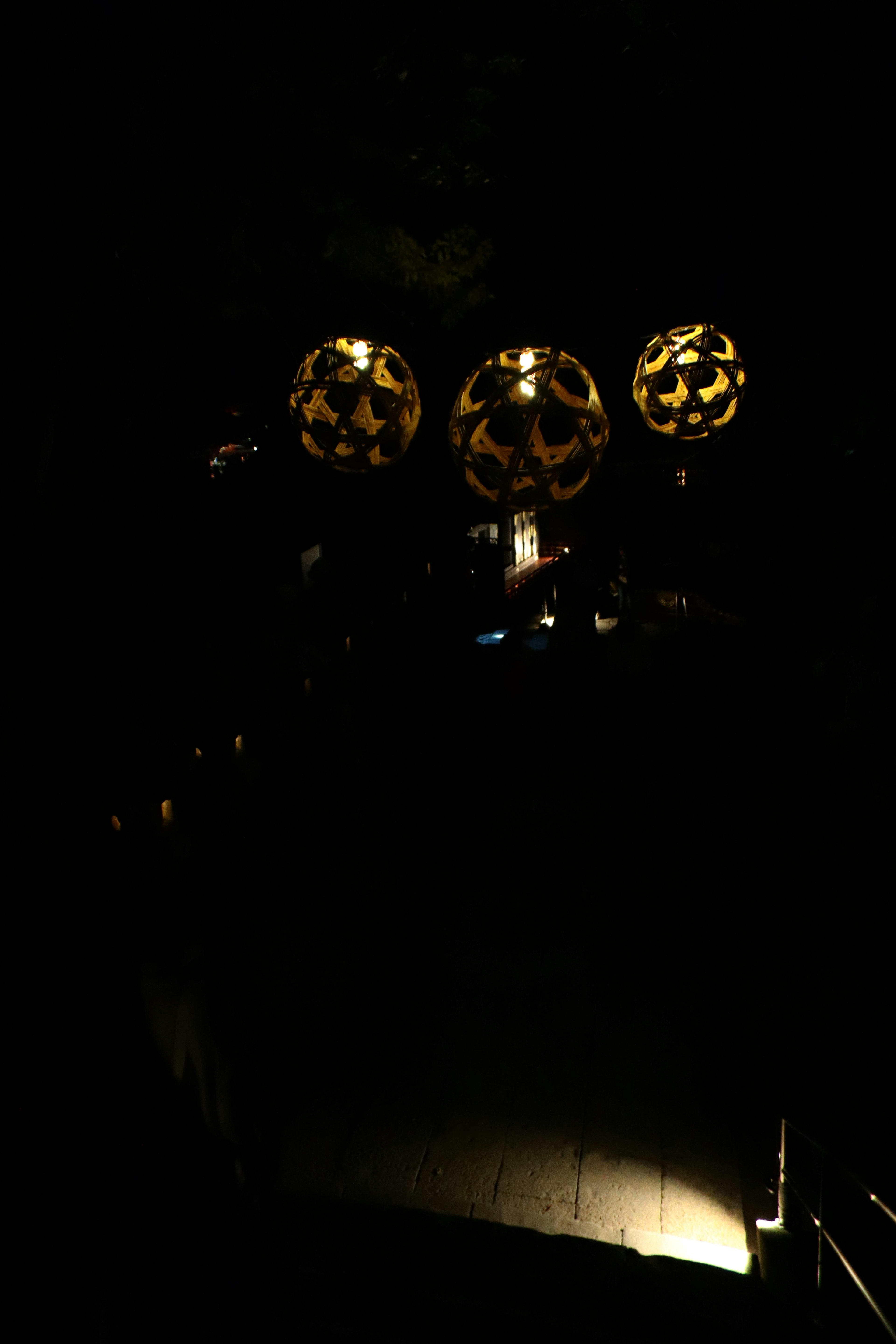 Image featuring three distinct yellow lamps against a dark background