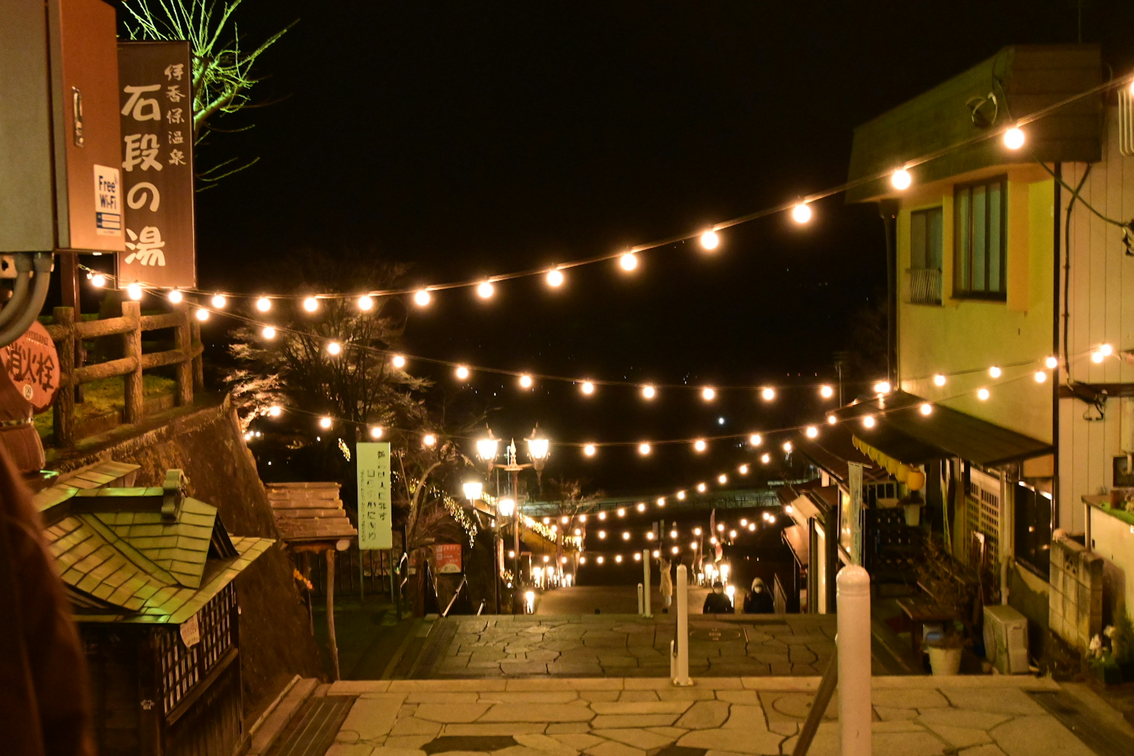 Charming street scene with string lights at night