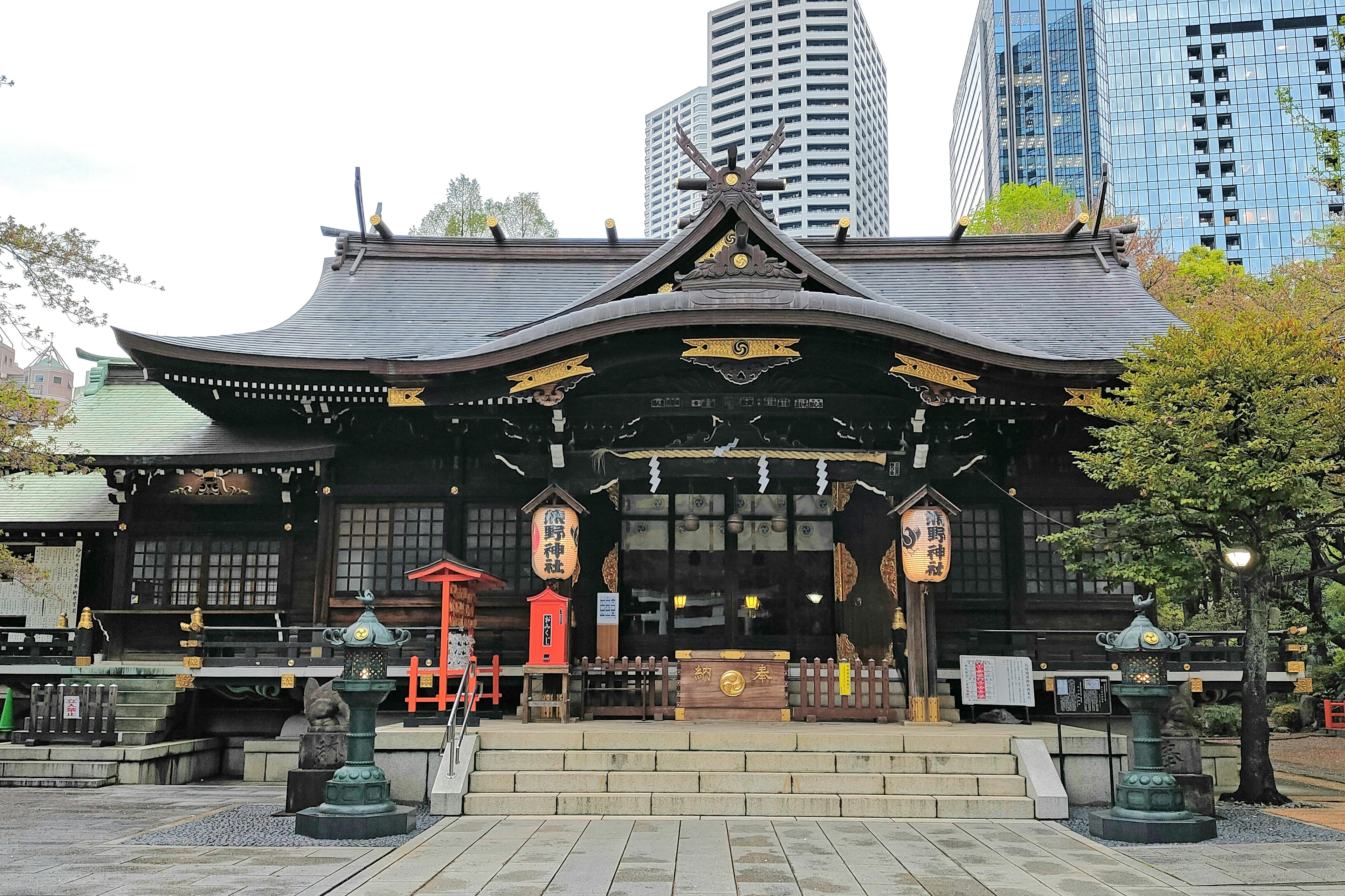 Traditional shrine building surrounded by modern urban architecture