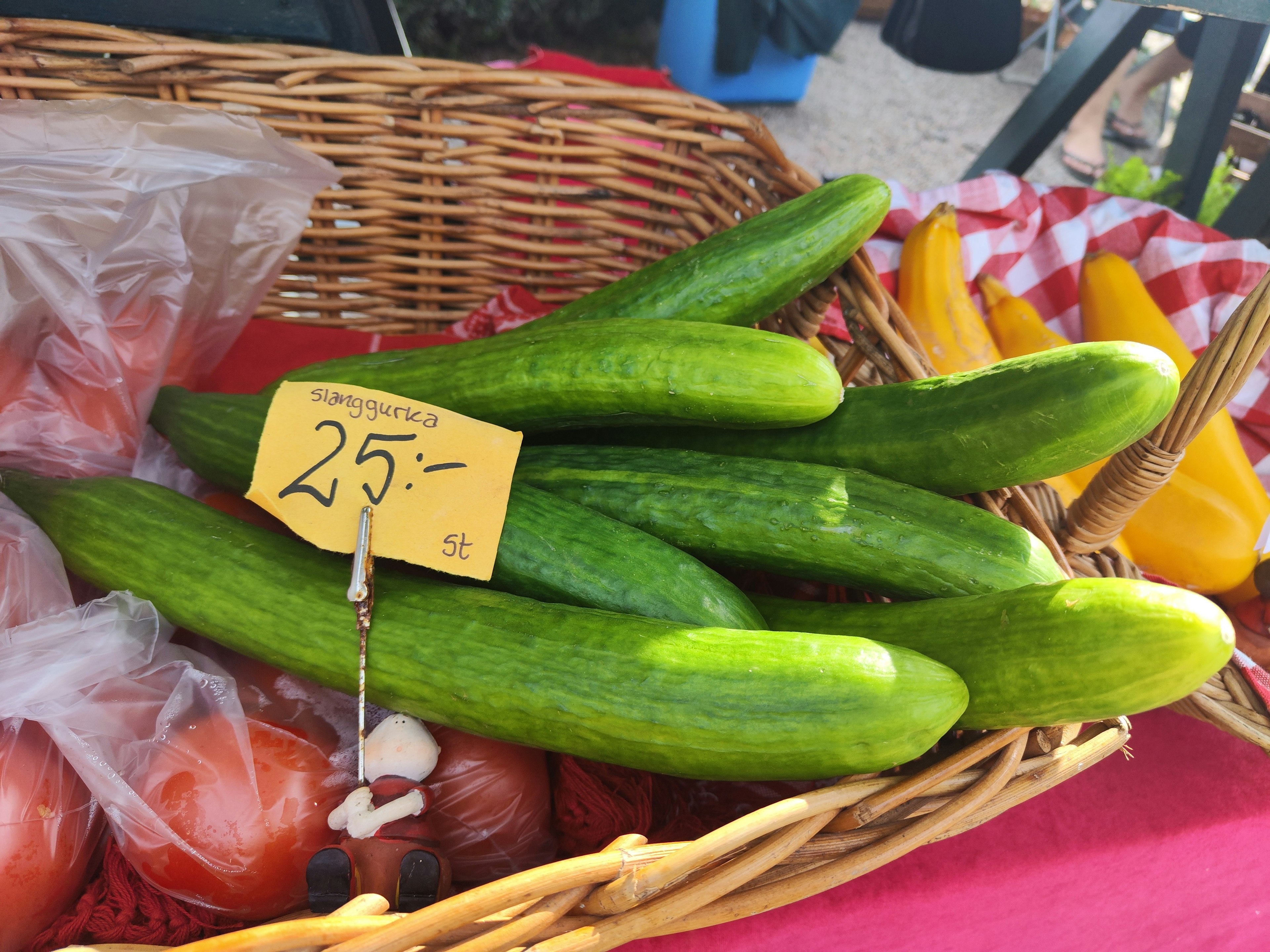 Fresh cucumbers arranged in a basket at a market