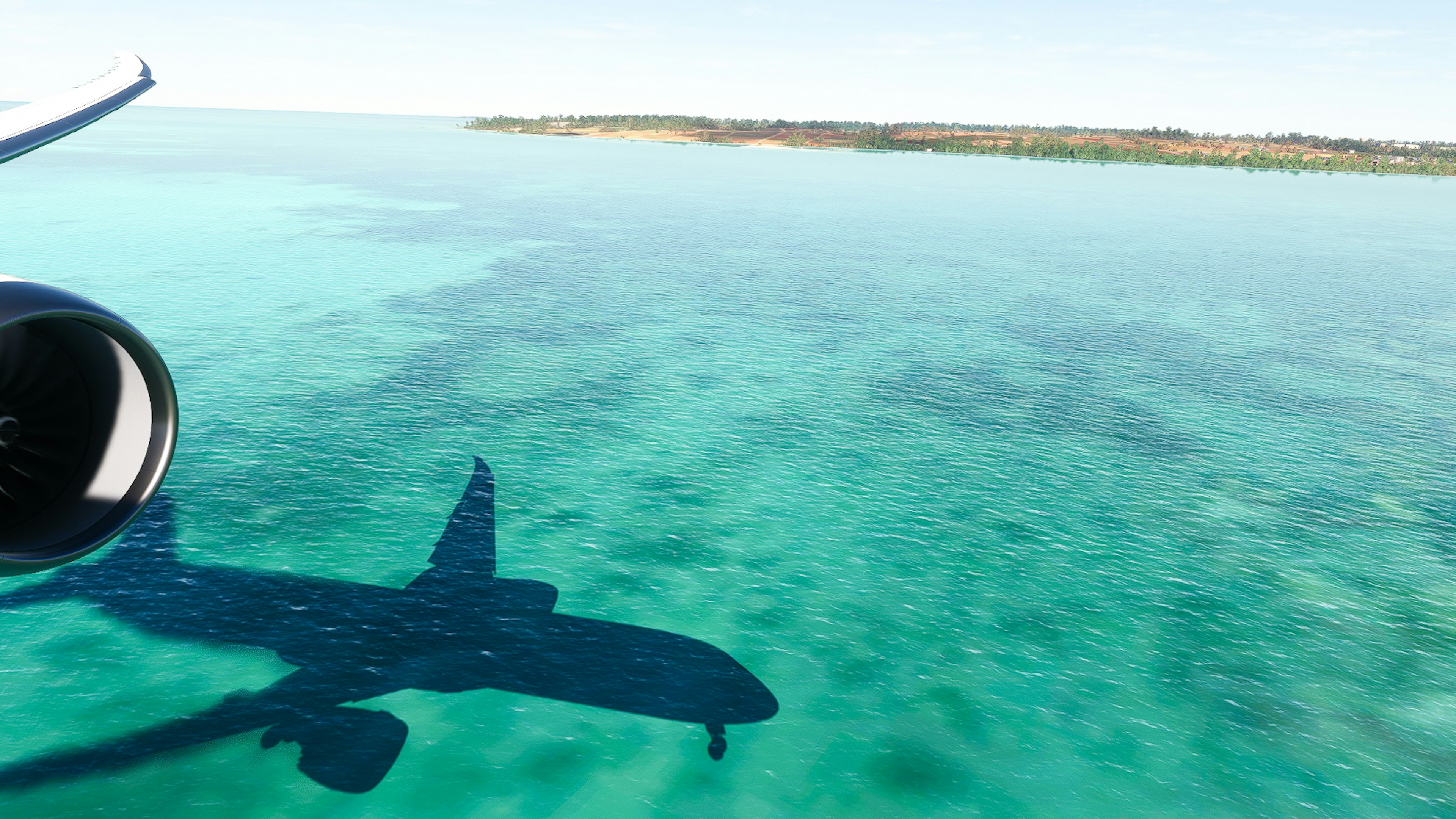 L'ombre d'un avion projetée sur l'eau turquoise