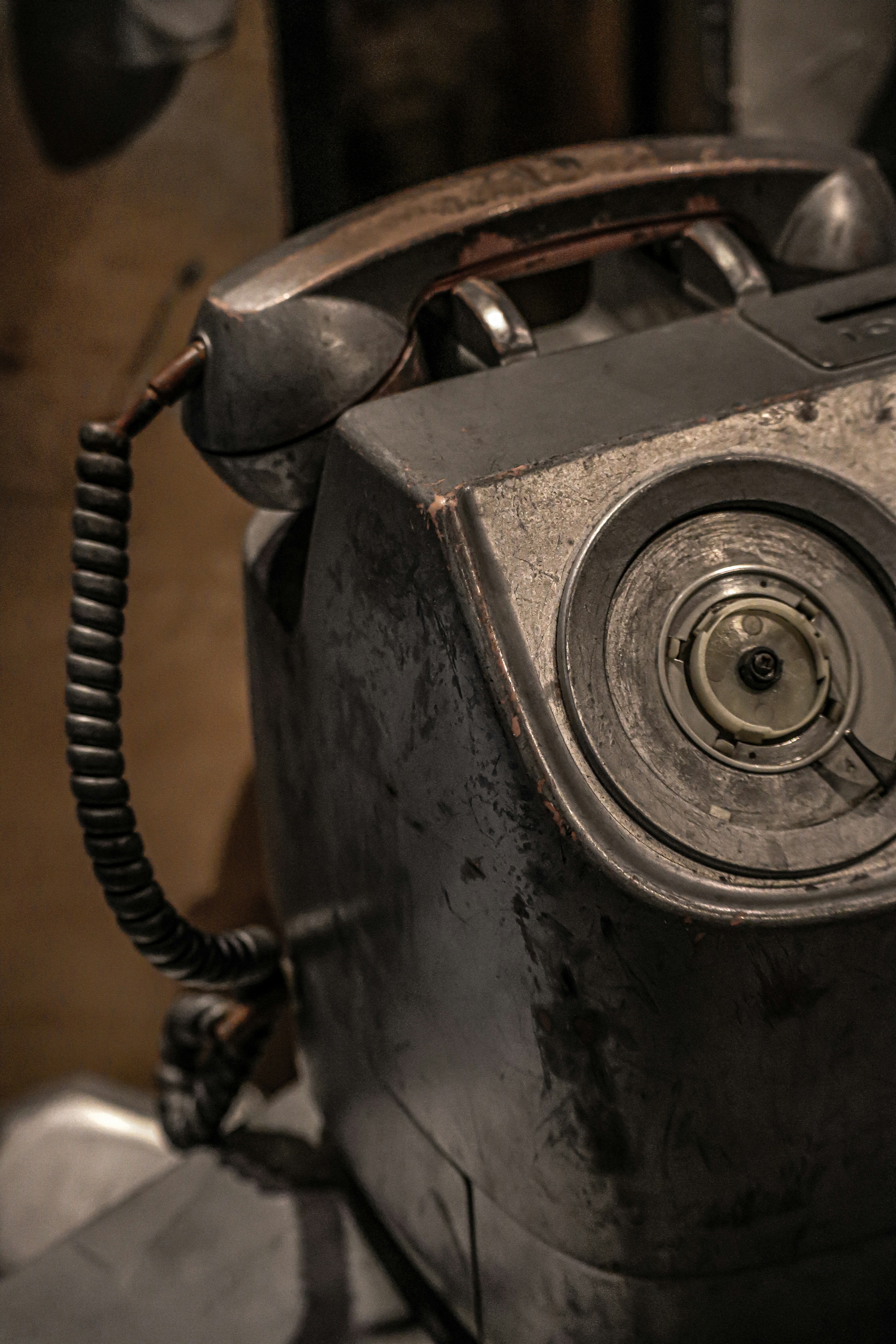 Close-up of an old telephone featuring rusted metal and vintage design