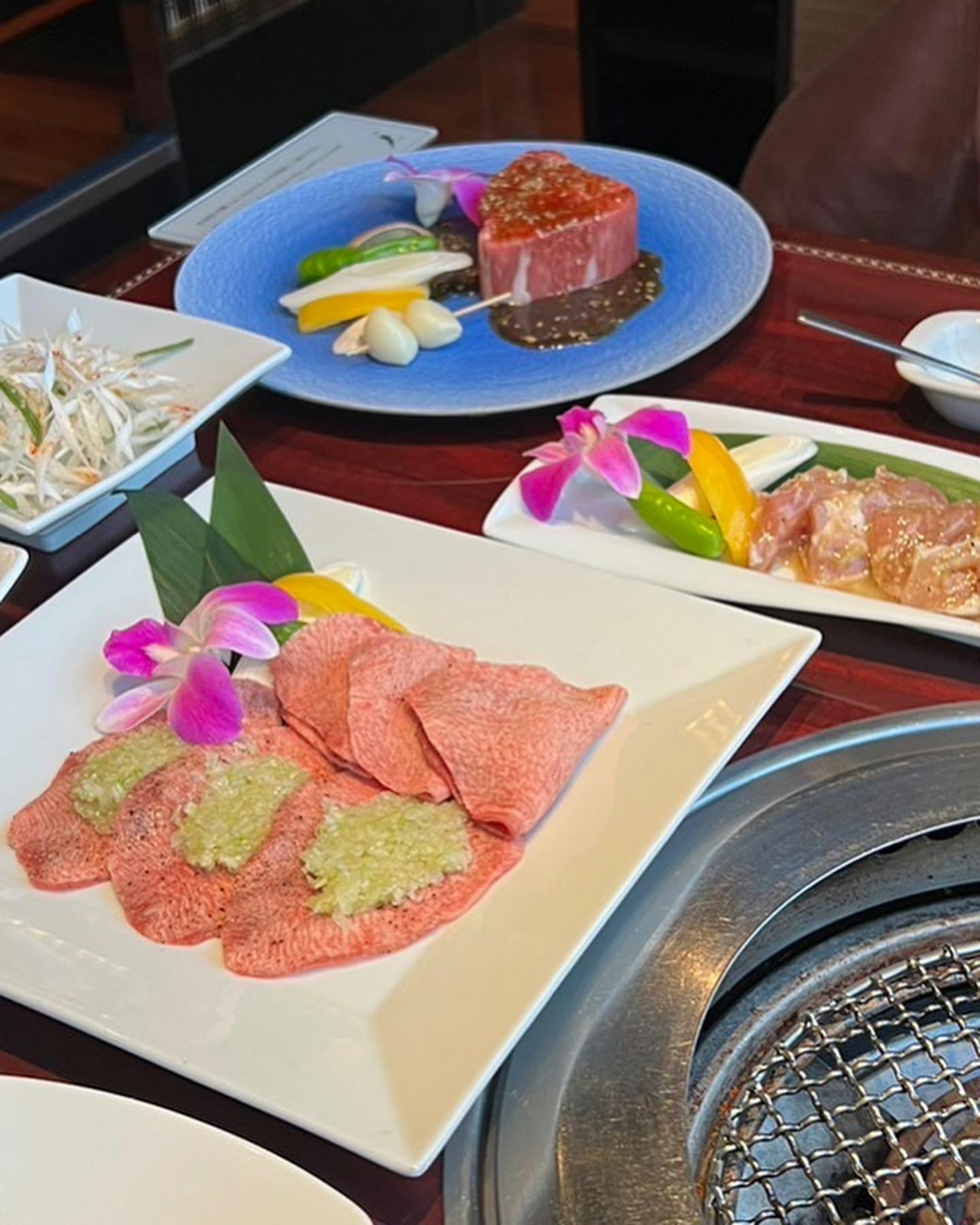 Beautifully arranged wagyu beef and fresh vegetables dish