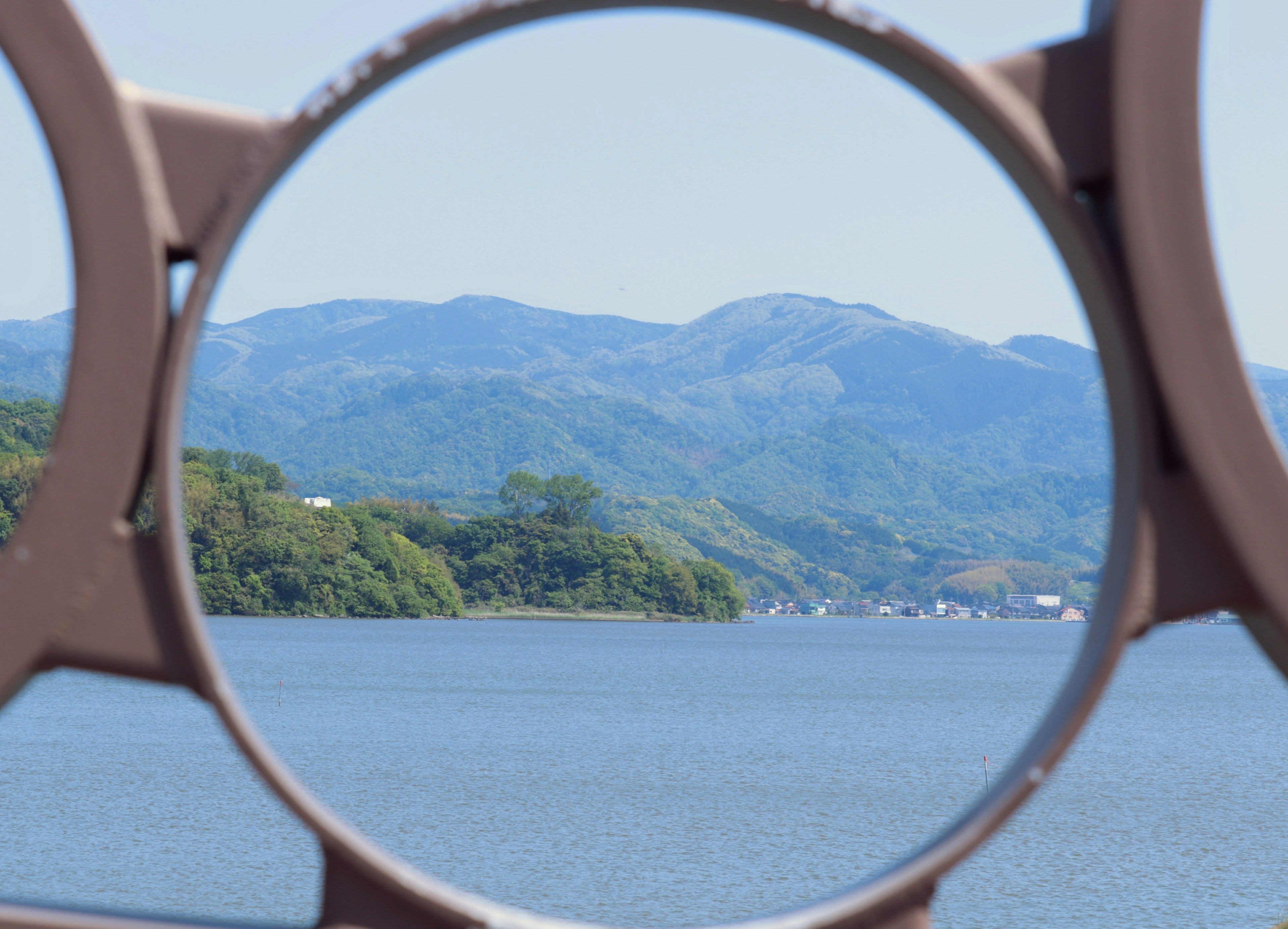 Scenic view of mountains and lake framed by a circular structure