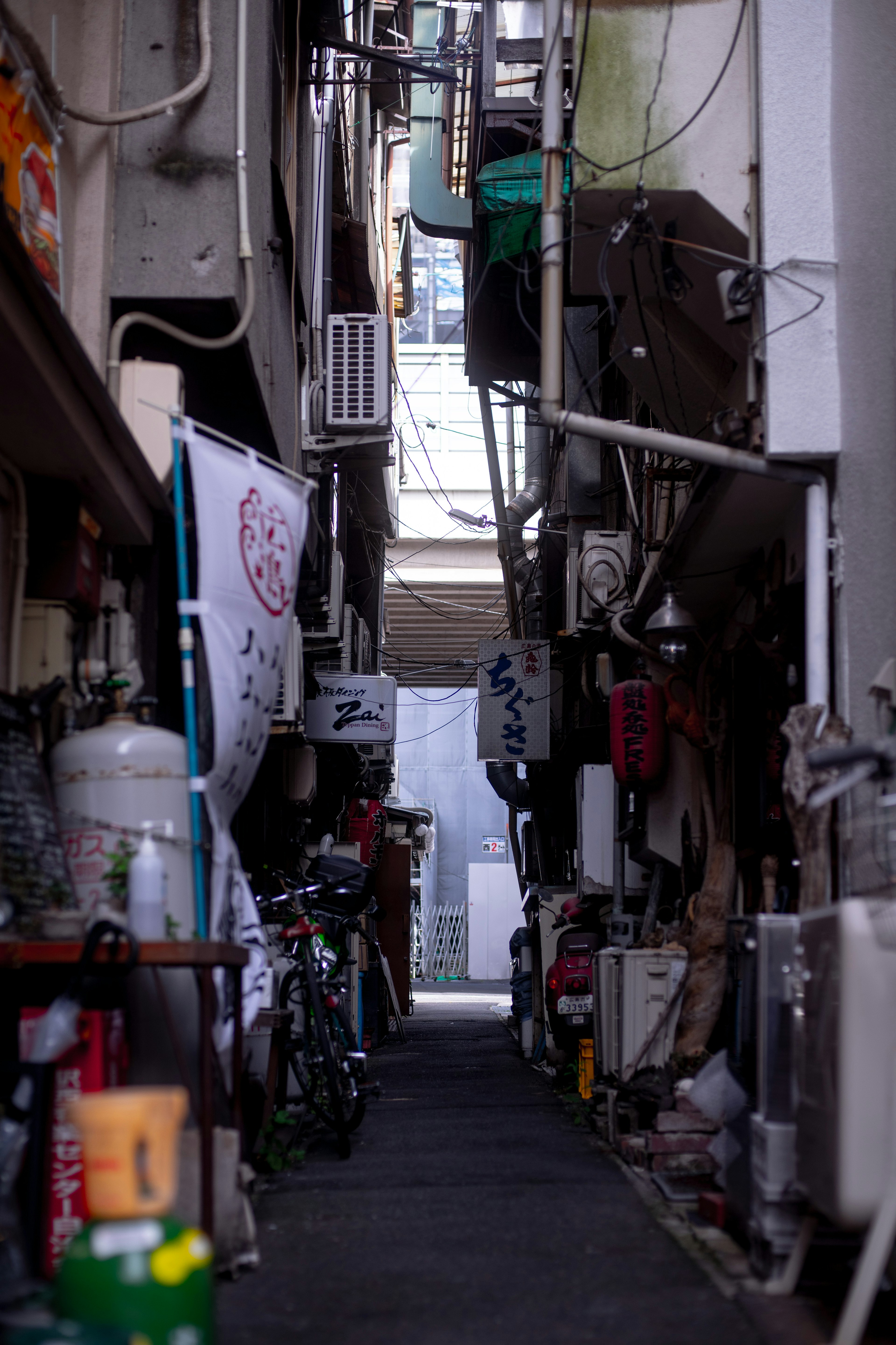 Narrow alley featuring restaurants and various items