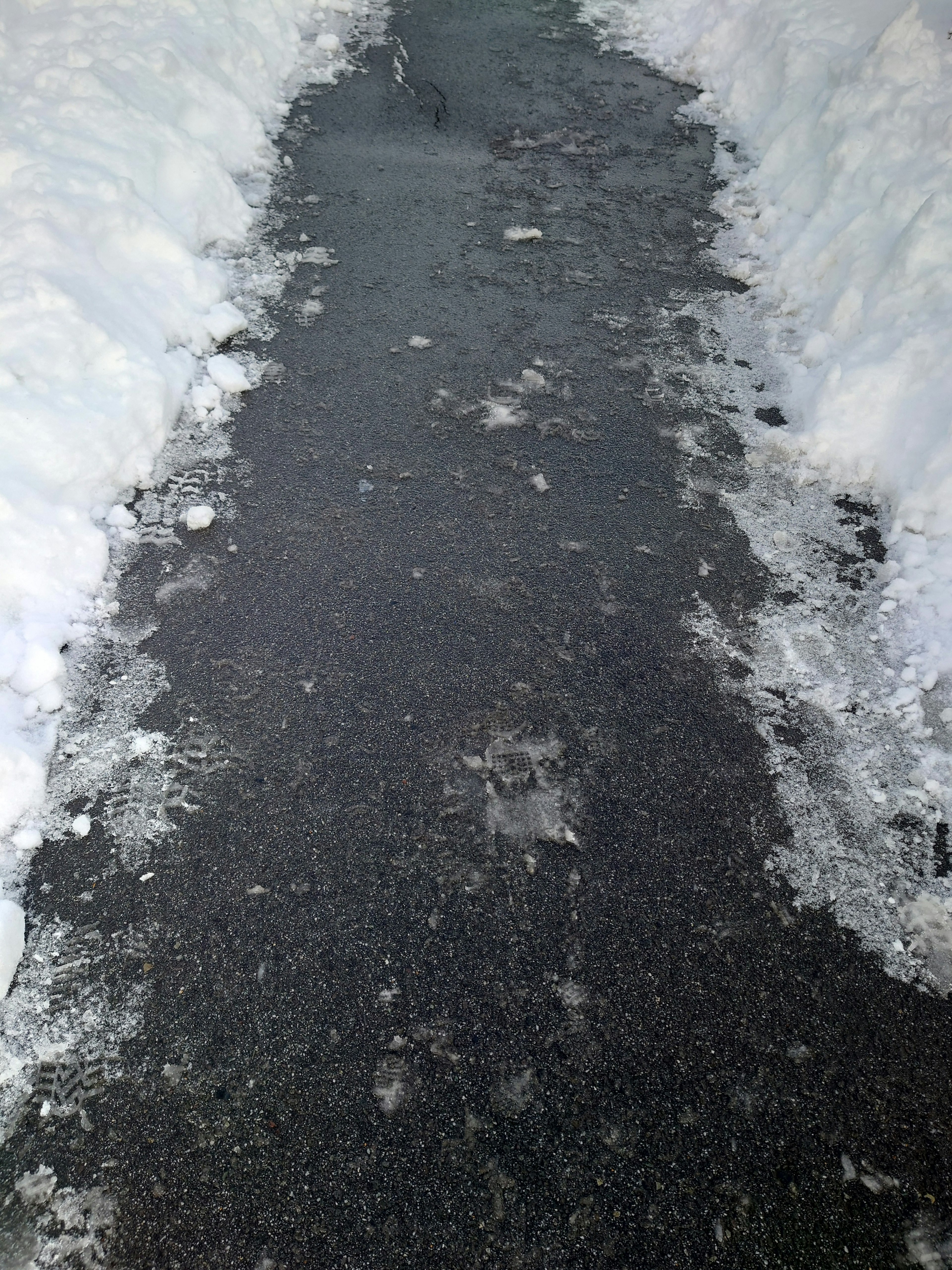 Paved walkway surrounded by snow