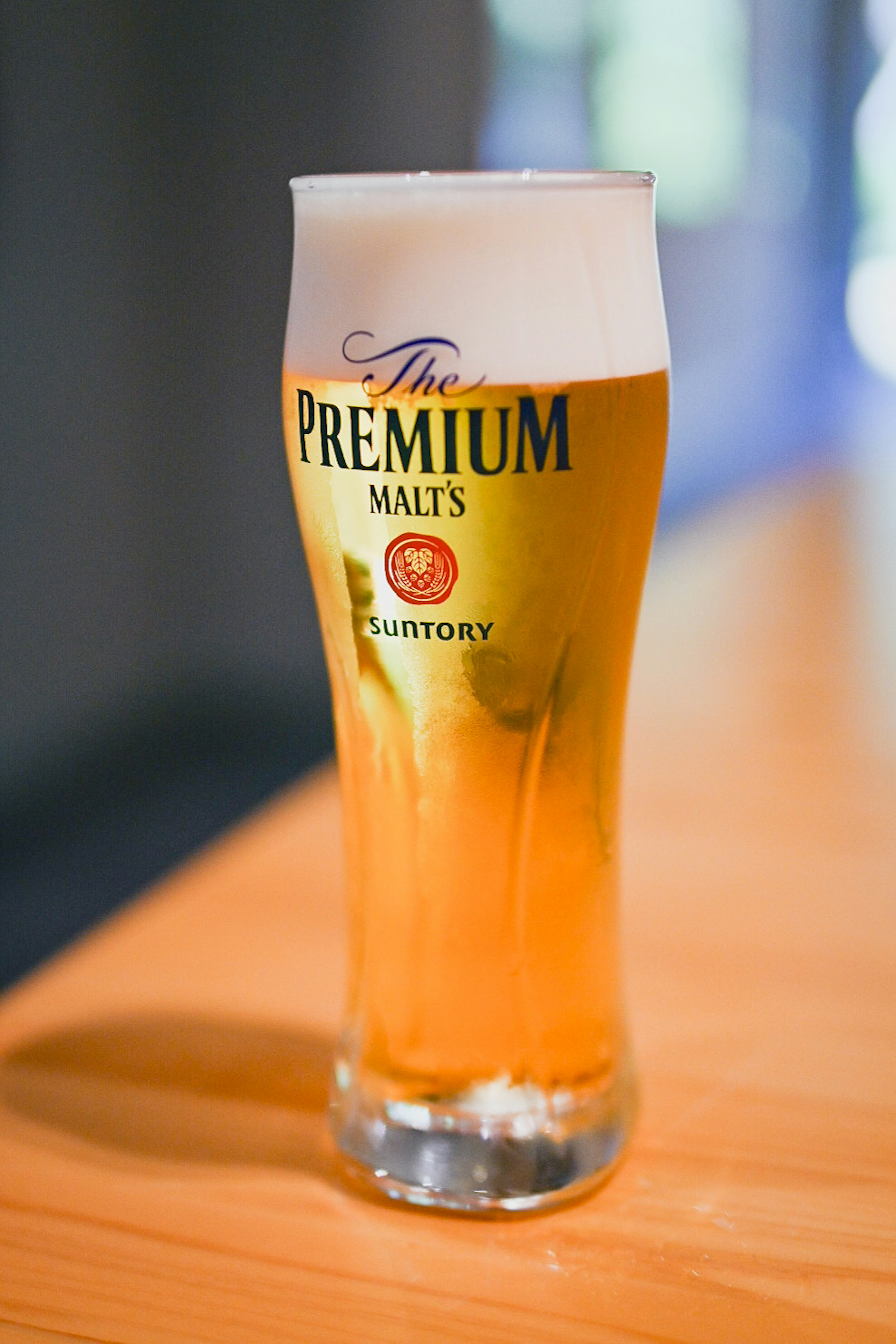 A glass of Premium beer on a wooden table