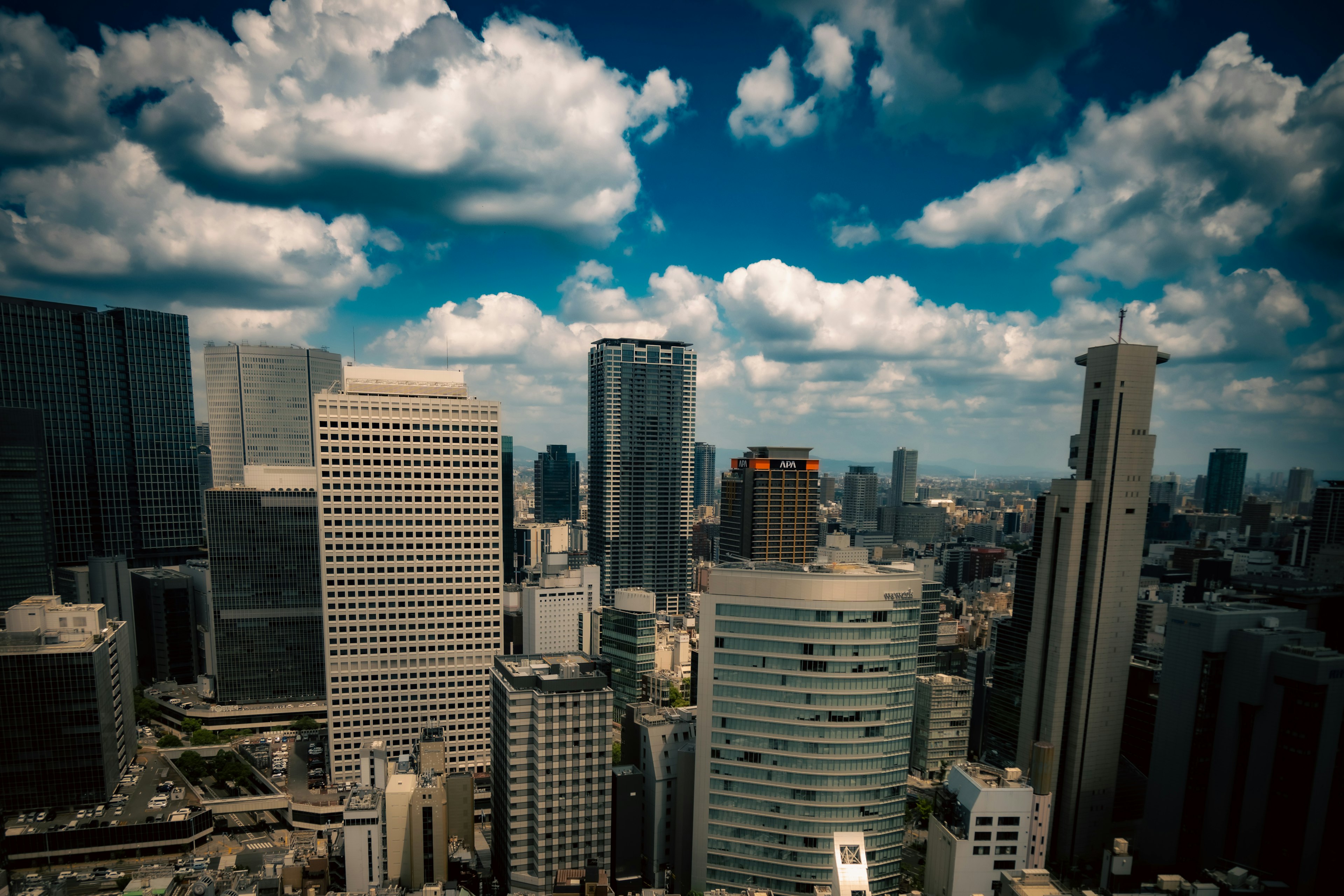 City skyline with skyscrapers and a blue sky filled with clouds