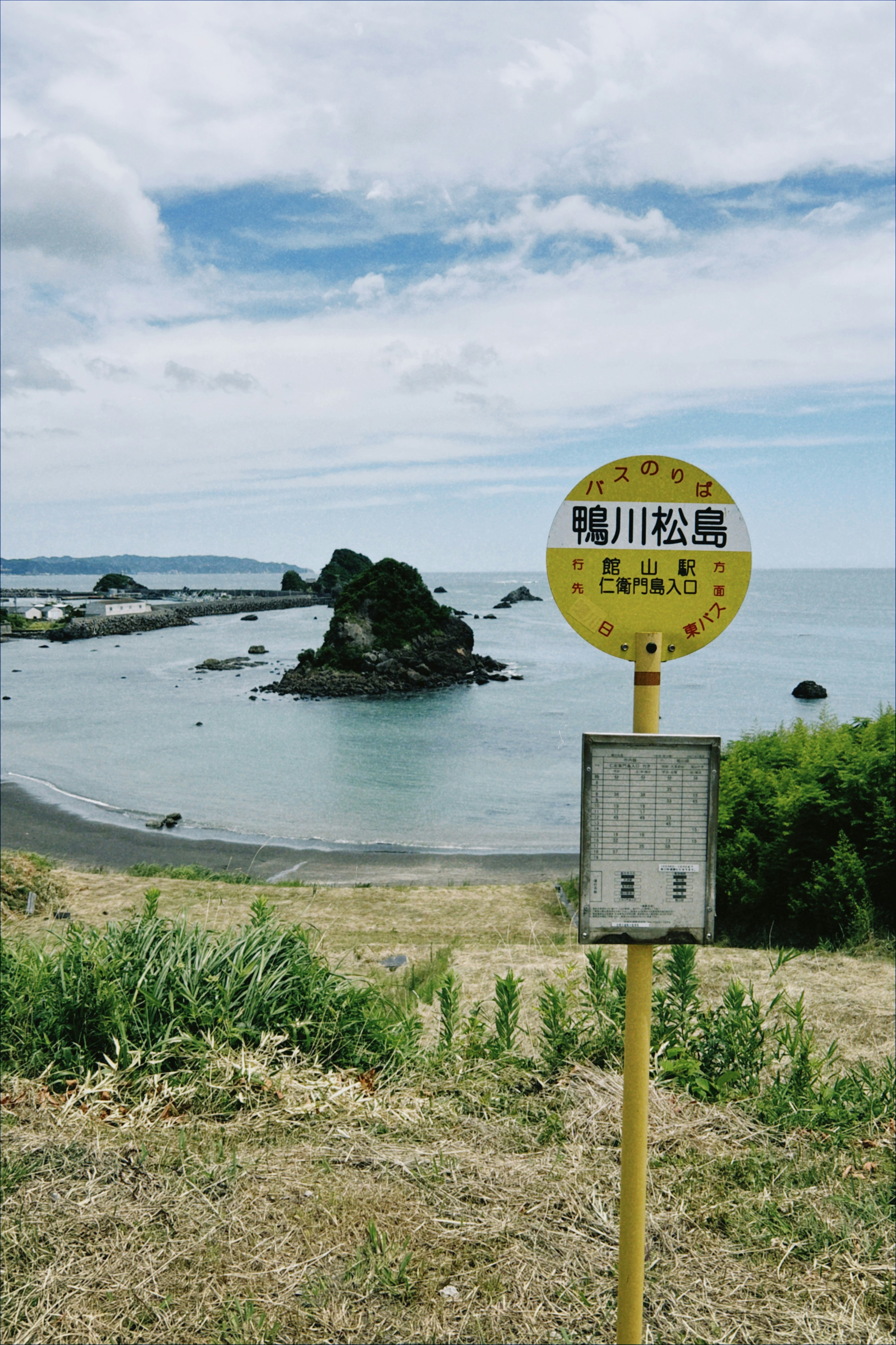 Coastal bus stop with rock formation and sea view