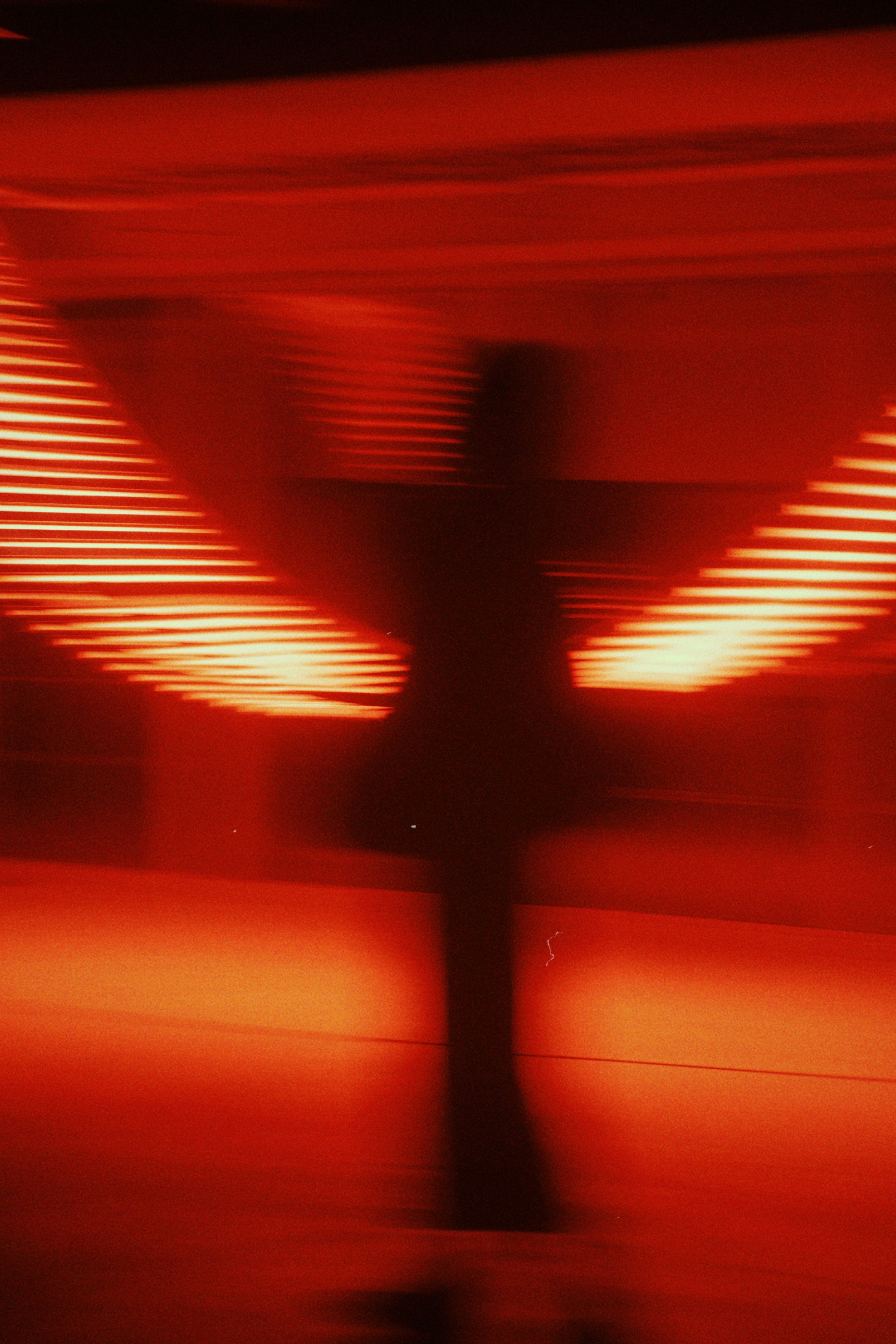 Blurred silhouette of a person in red light