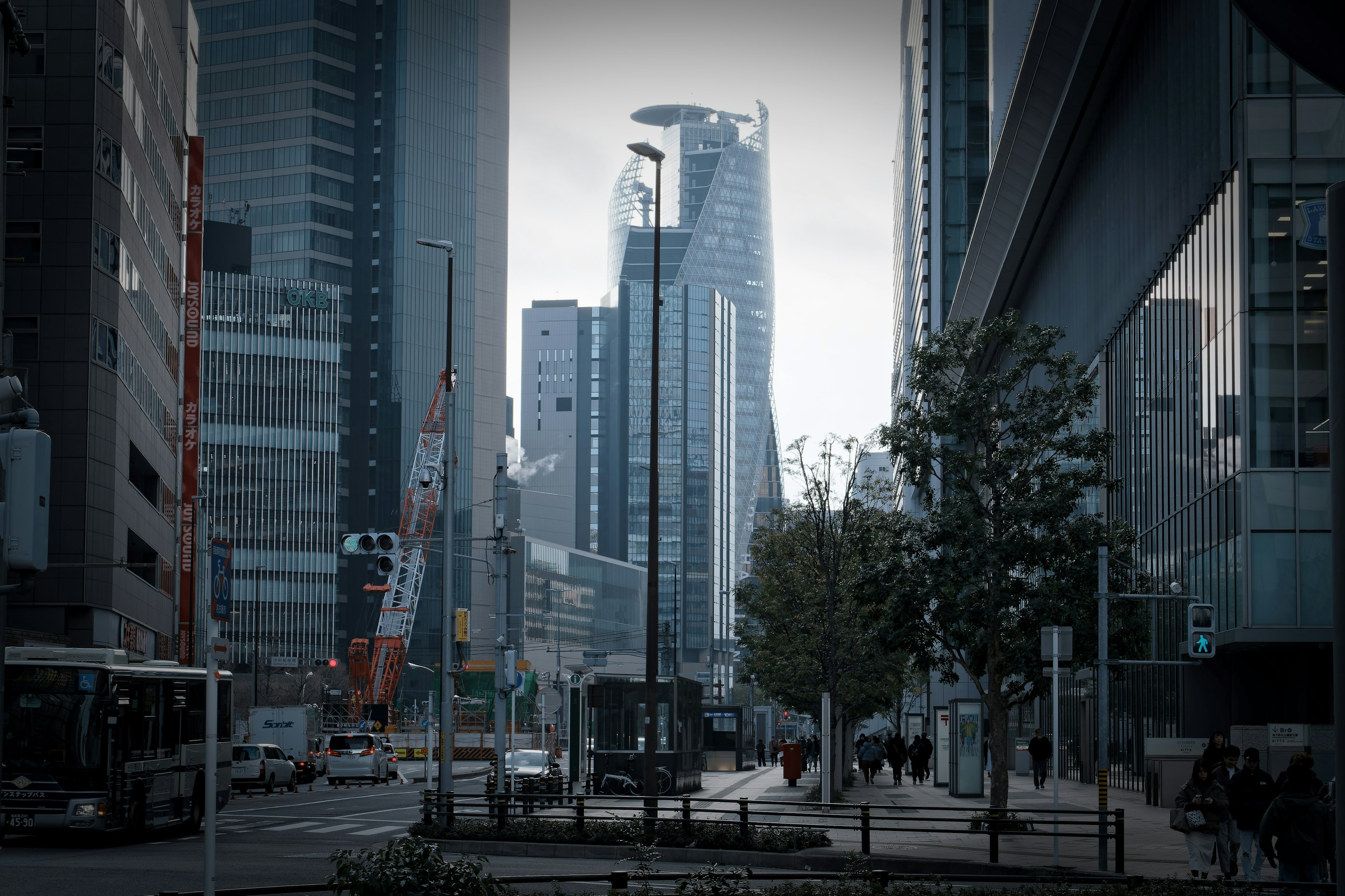 Urban landscape with skyscrapers and busy street featuring people and vehicles