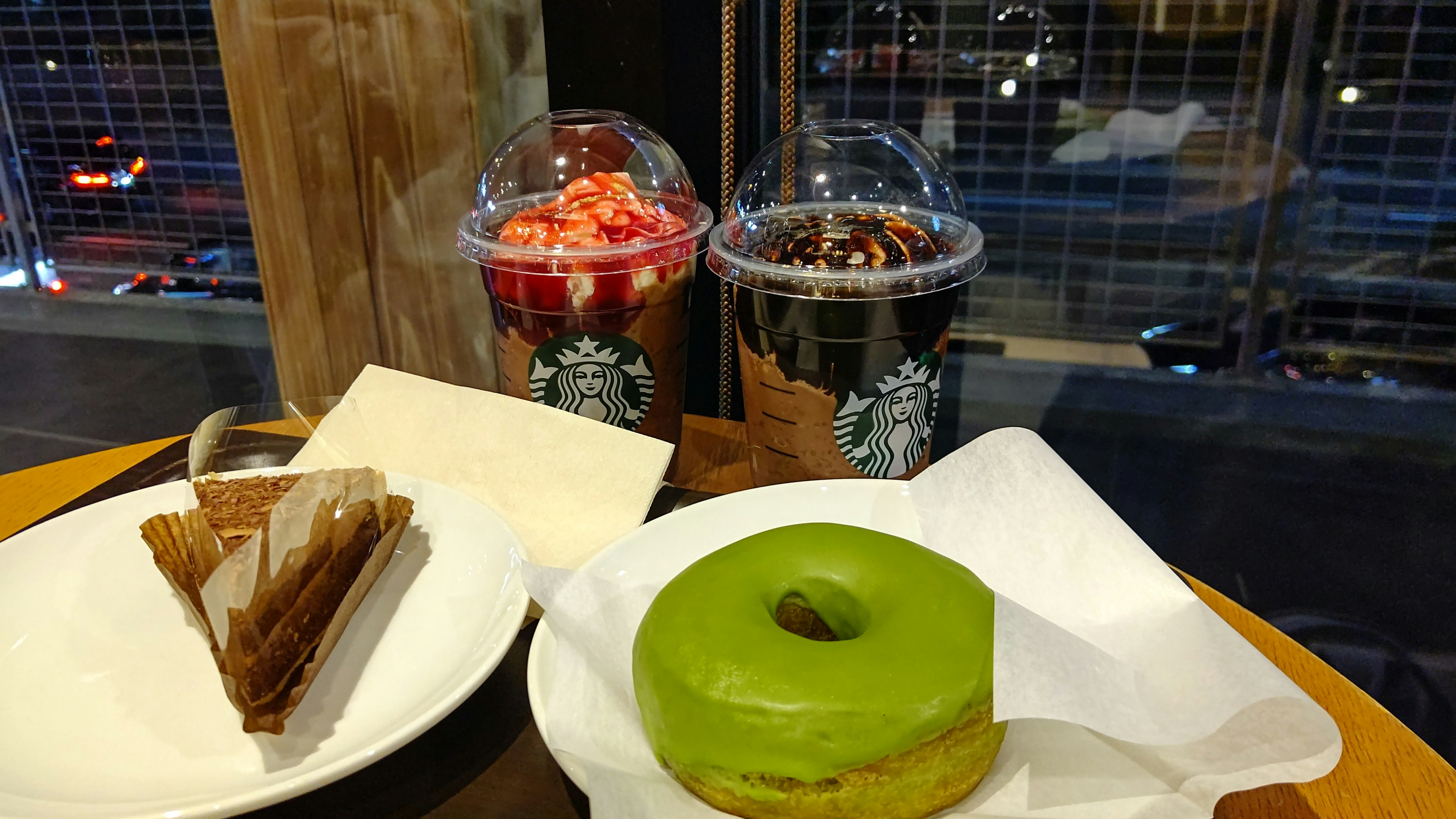 Cafe table with green donut and desserts