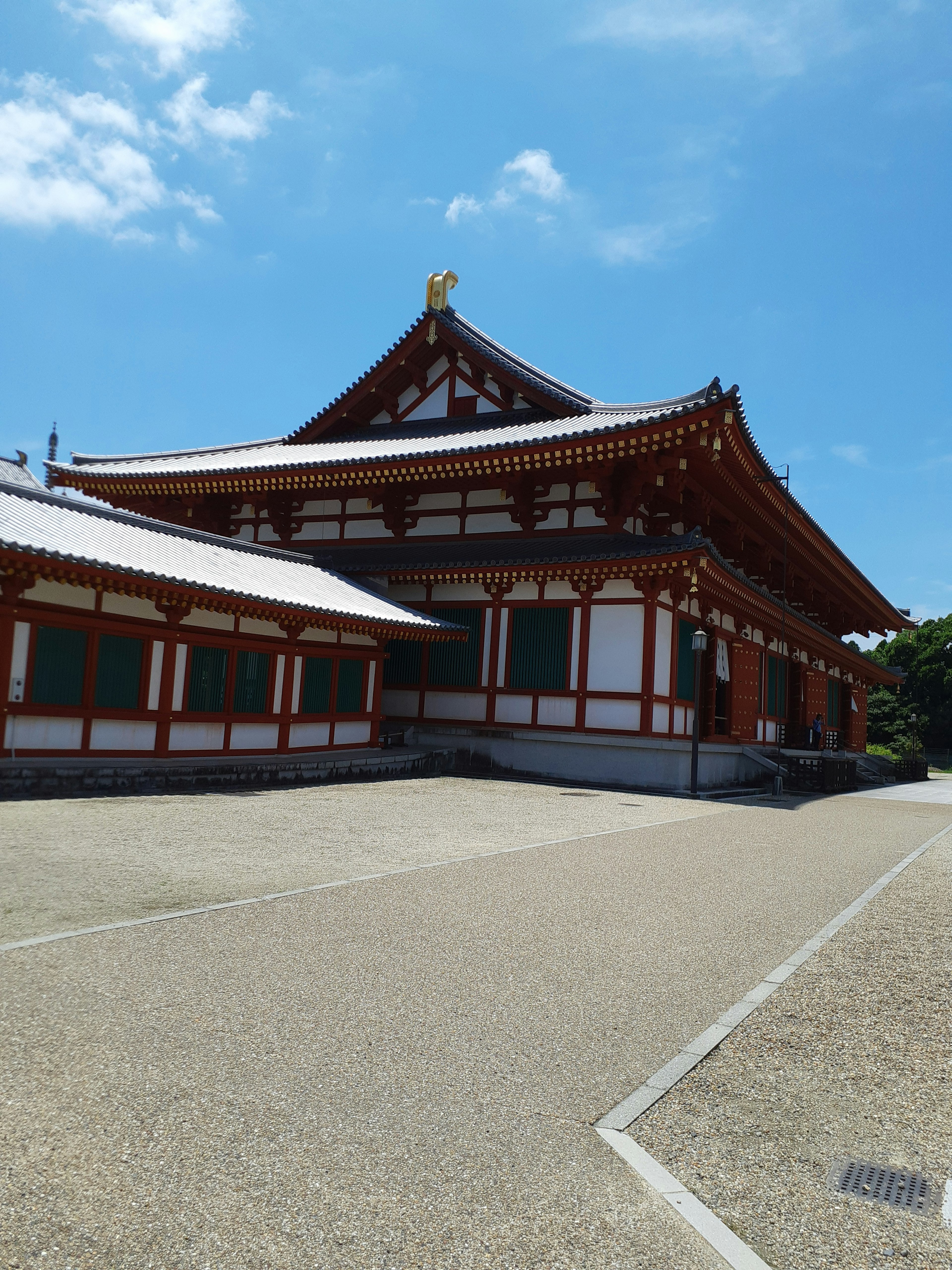 Traditional Japanese temple building under a blue sky