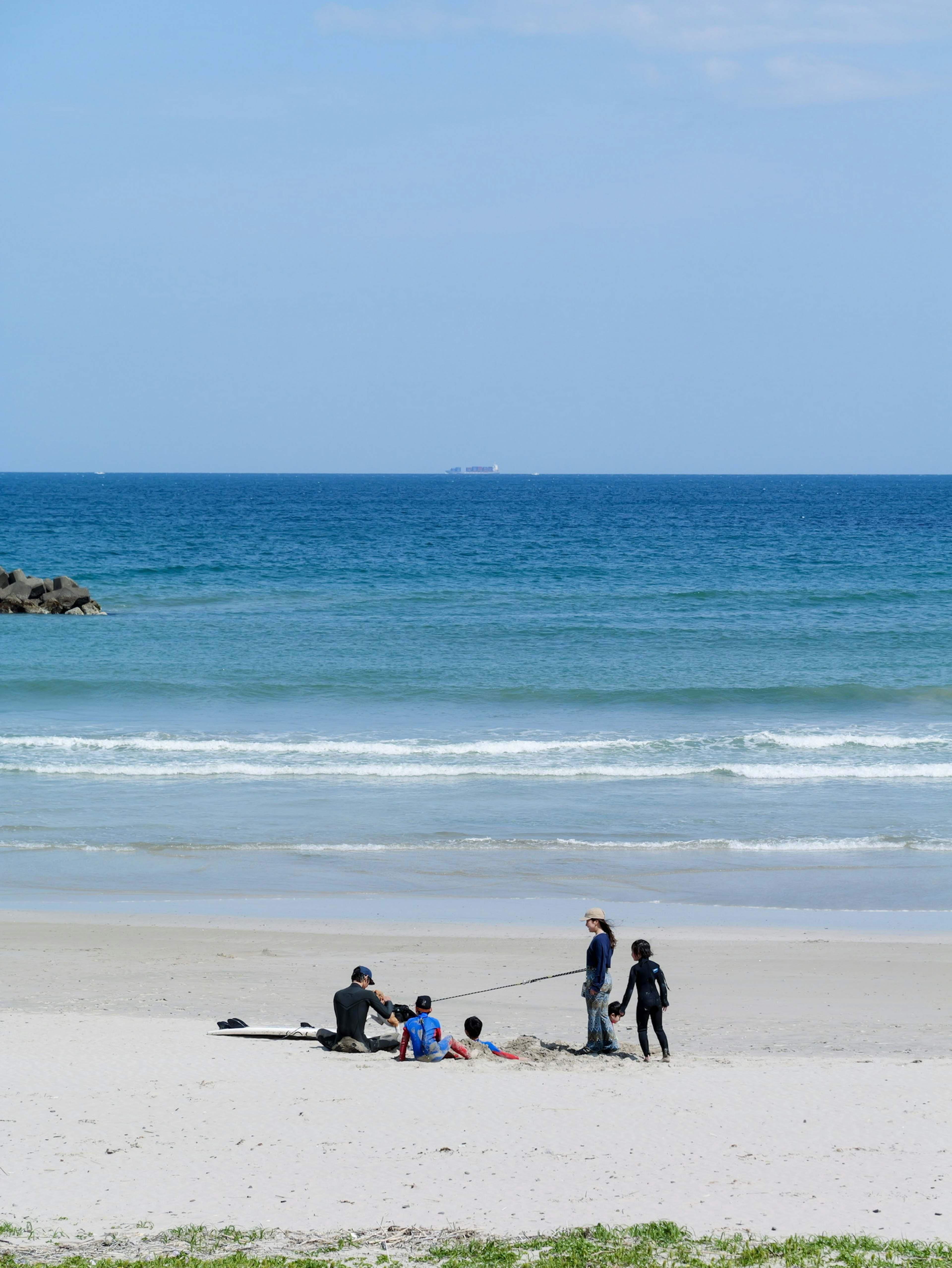 People enjoying a sunny beach with gentle waves