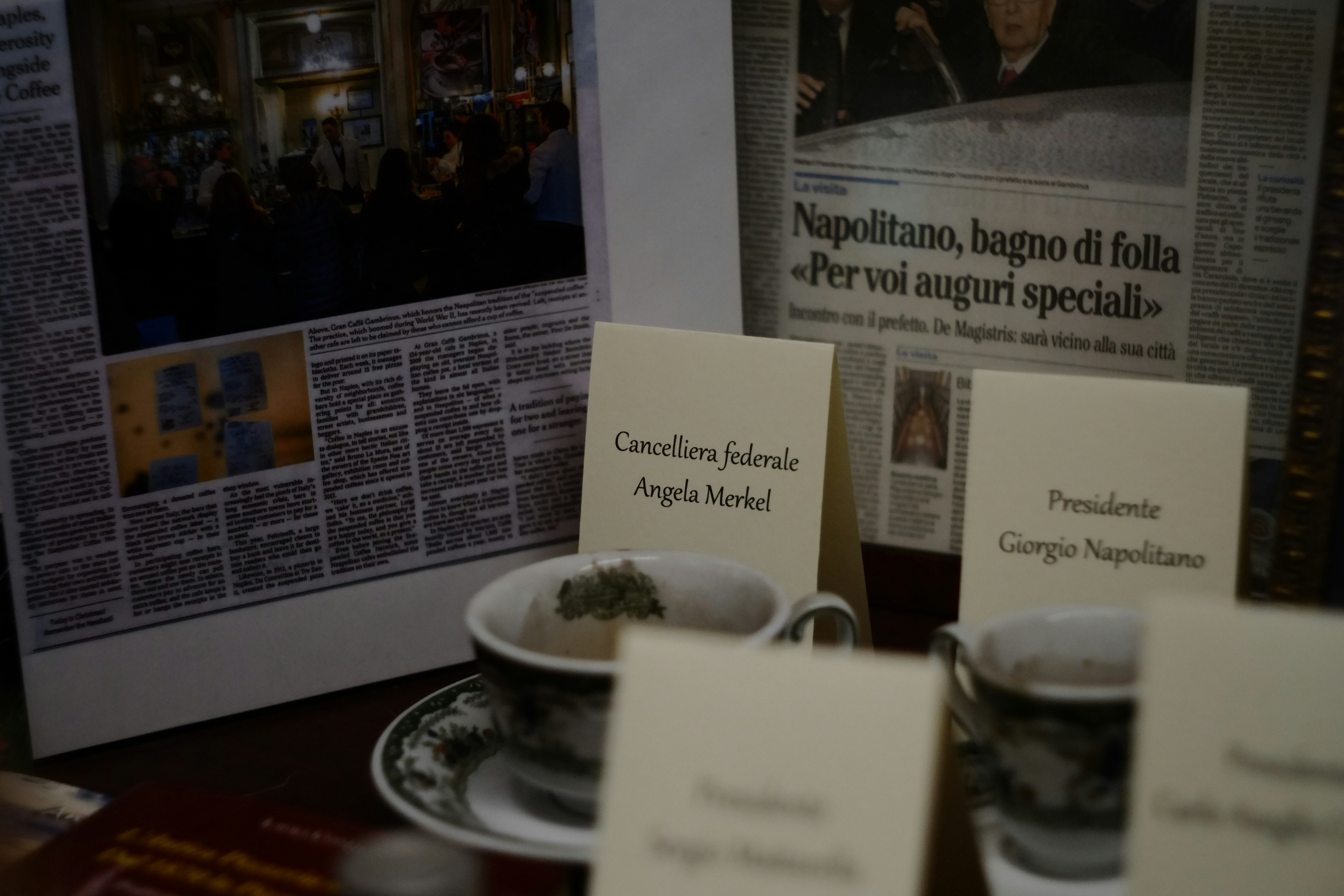 A scene featuring cups and plates arranged around a newspaper