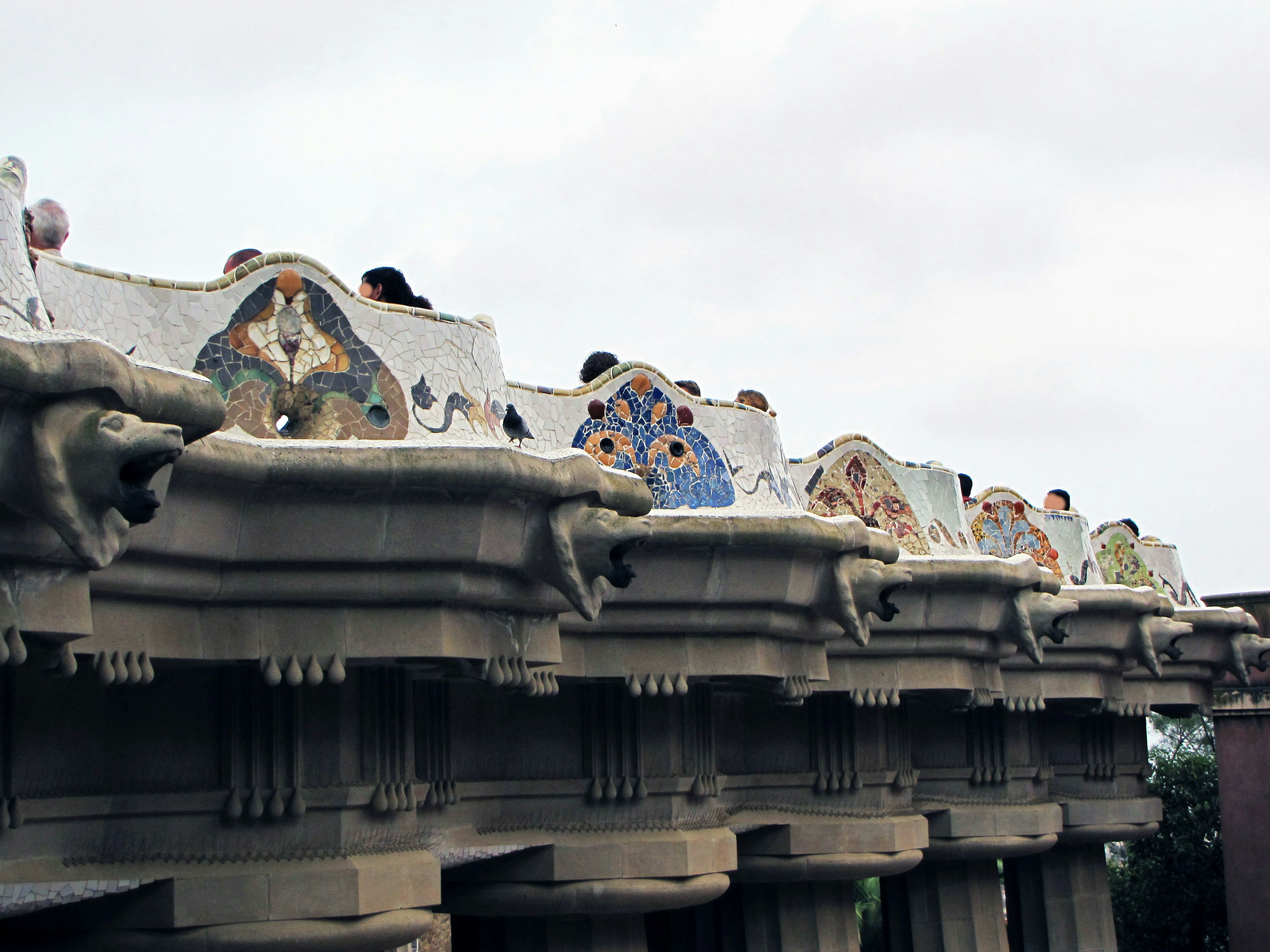 Decorative roof section of Casa Batlló featuring ceramic tiles and sculptures