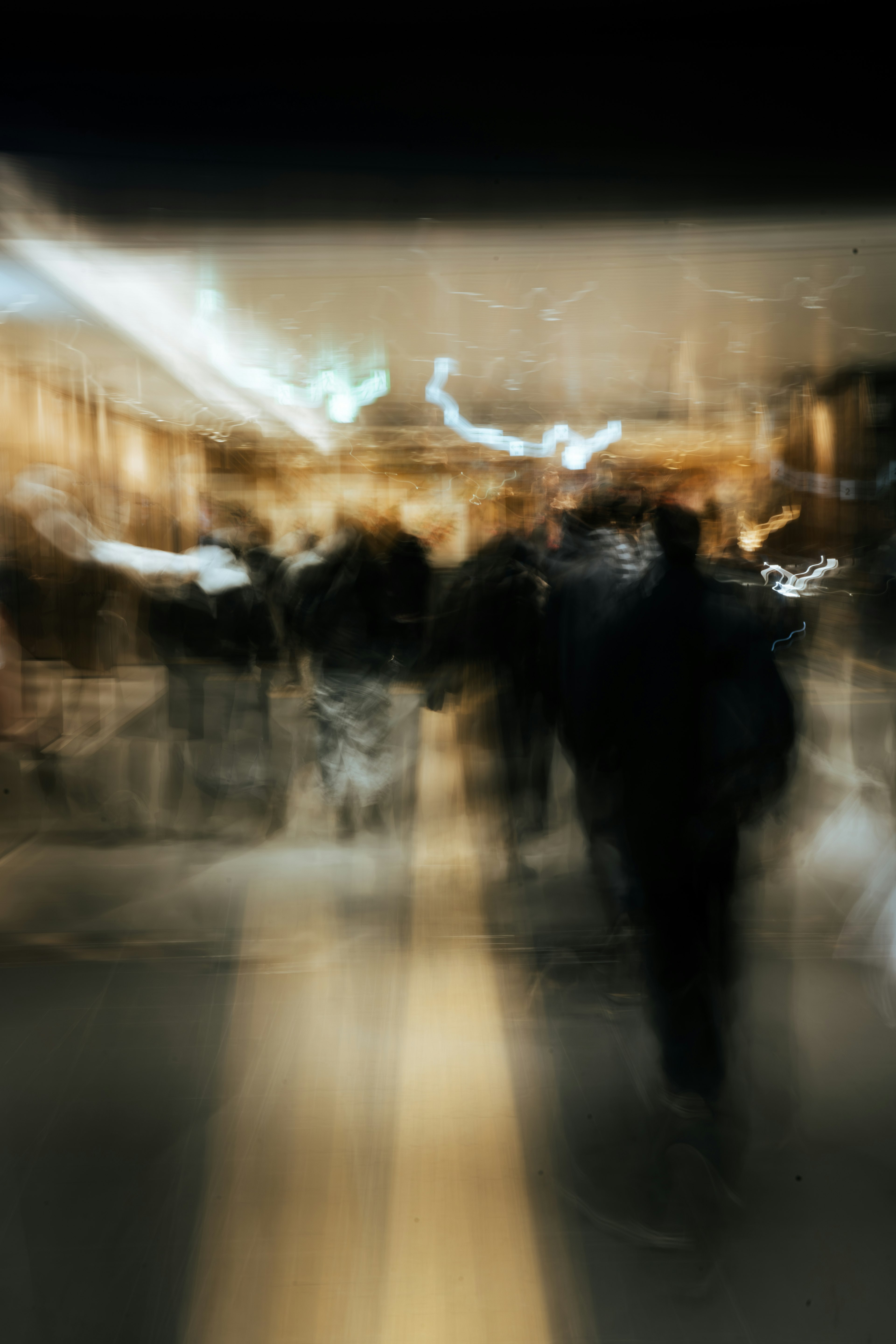 Blurred cityscape with people moving and streaks of light